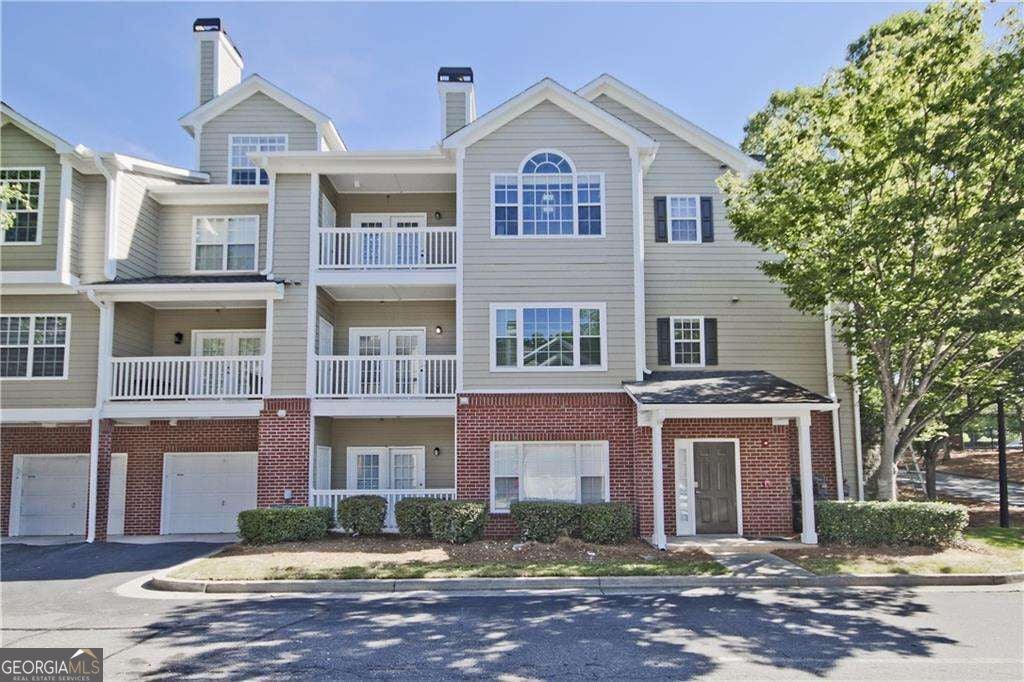 Photo of 8102 WOODLAND Lane #8102, Alpharetta, GA 30009 (MLS # 10835318)