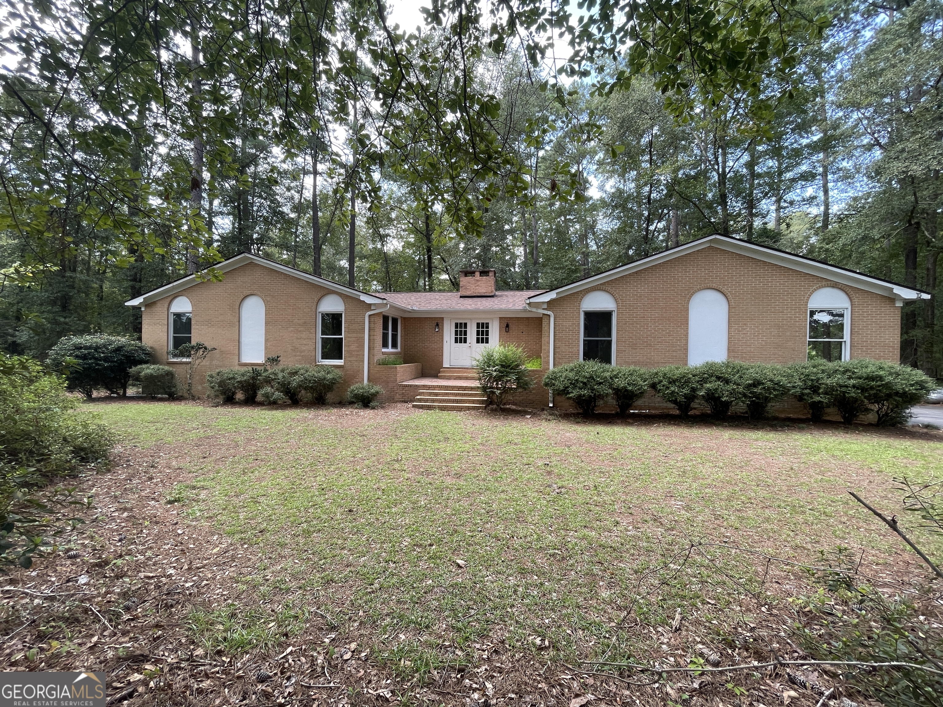 This all-brick home has recently remodeled. Home has new roof, new LVP flooring, new light fixtures, new kitchen cabinets and solid surface counter tops. The home has been completely repainted with neutral paint colors. Features approx 2232 sq ft of heated & cooled sq ft. Home has formal dining room, eat in kitchen, spacious living room with new gas log fireplace. Kitchen has new stainless teel appliances. Large sunroom overlooking the private wooded back yard. Enjoy the window into nature. Owner's suite is spacious w/ attached bath w/walk in close. Basement area accessible from in or out of the home. Great for storage. Approx 1000 sq ft of basement. 2 car carport w/storage room. Home sits off the road tucked into the trees. Private yet only a few miles to town.