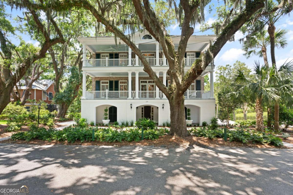 Welcome to your dream coastal retreat! Imagine enjoying gentle ocean breezes and serene ocean views through the live oaks from the double verandas of this stunning Charleston-style beach home. Nestled on quiet Florence Street, you have the best of all the island has to offer-just steps from the most secluded St. Simons beach and perfectly situated a short stroll from both the lively Pier Village and the exclusive oceanfront resort at Sea Island Golf Club and Lodge. This beautifully designed home by architect John Rentz offers 5,300 square feet of luxury living. With five spacious bedrooms, including two primary suites, you'll have plenty of room for family and guests. Designed for hospitality and good flow, hosting gatherings will be a delight as spacious living and formal dining flow to the expansive veranda with ocean views and breezes. The home's parking for eight or more vehicles is unmatched for the area and makes for easy entertaining. You'll enjoy watching ships pass from the double verandas and appreciate the fine details such as brick and wood floors, natural light pouring through transom windows, exquisite crown moldings, and the charm of interior plantation shutters throughout the home. Exterior shutters, formal garden, pocket doors, a cozy fireplace, and grand staircases add to the home's timeless sophisticated yet welcoming atmosphere. Its solid block and Savannah Gray brick construction is peerless. Convenience is key with modern amenities like an elevator, a large laundry room, a dedicated workout room, spray foam insulation, epoxy garage flooring, outdoor shower, multi-purpose closets on the main level, and two garages with three ground-level storage rooms for golf carts, kayaks, seines, and fishing and sporting gear. Tucked into the majestic live oaks, 119 Florence has unexpected privacy for its convenient location. We challenge you to find another St. Simons residence with ocean views through massive moss-draped live oaks which provides a unique and spectacular experience. This home is positioned and designed for enjoying the St. Simons Island coastal lifestyle to the fullest. Bike to community hub of Mallery Park for tennis, pickleball, the playground, and the sweetest hometown baseball park that is a true slice of Americana. Seine, fish, kayak, sailboard, crab, shell hunt, and clam 200 yards from your door. Take a short stroll west to the pier for dining, lighthouse concerts, community festivals, ice cream, and boutique shopping, or take a short stroll east to indulge in Sea Island's world-class golf, oceanfront pool, breathtaking bagpiped sunsets, and five-star dining. This exceptional property offers the best of coastal living. Schedule your private showing today and step into your new life of coastal luxury and leisure! Listing agent serves as executor for the estate holding the property.