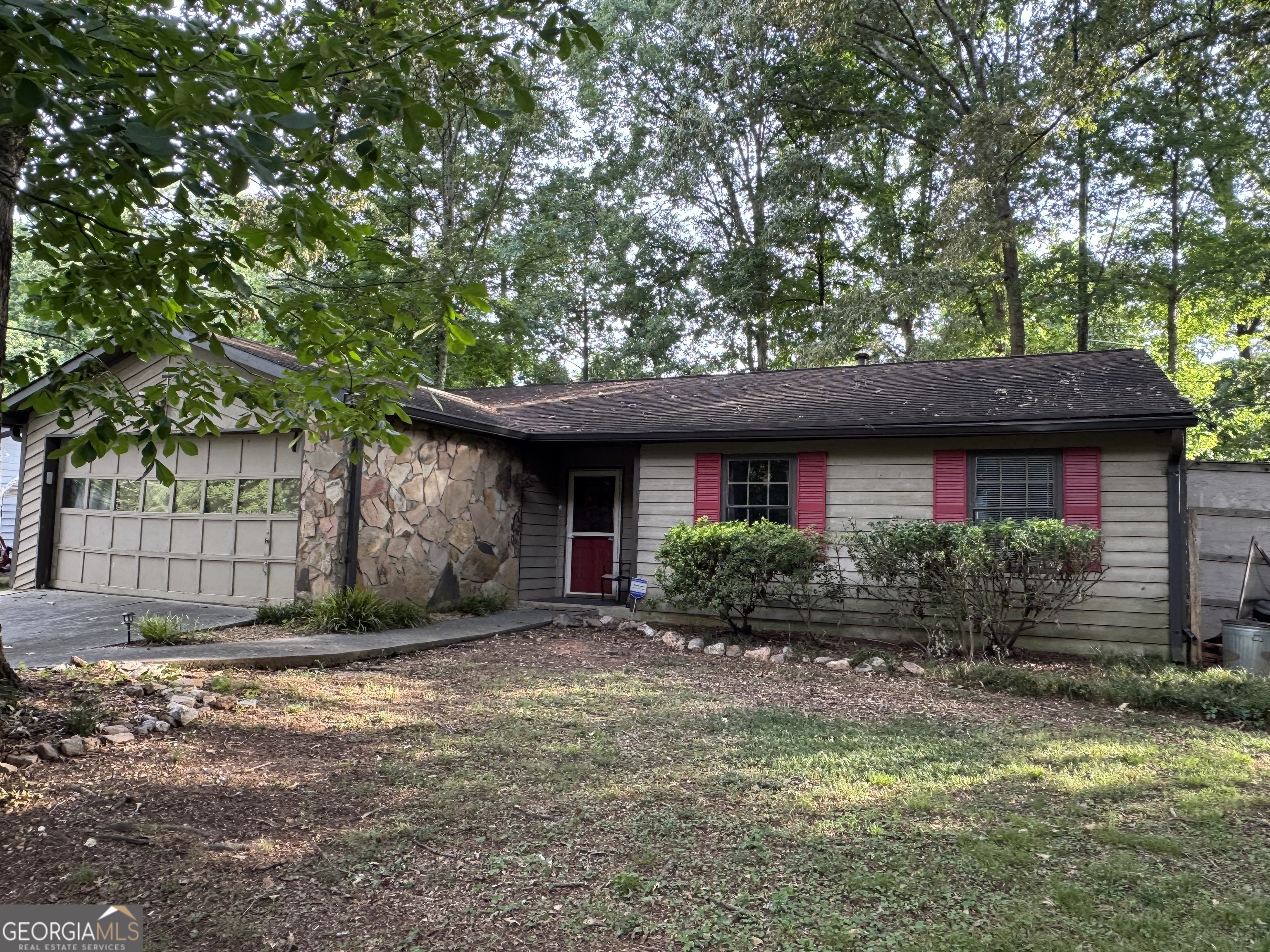 Nestled in a desirable and expansive community, this lovingly maintained 4-sided wood-sided ranch offers a rare blend of comfort, personality, and opportunity. With easy access to top schools, vibrant shopping centers, and major highways -- including Sugarloaf Parkway and Highway 316 corridor -- you'll enjoy both convenience and connection. Interior Features: A stylish mix of hardwood, tile, carpet, and finished concrete floors adds character and function to every room + Efficient galley-style kitchen with abundant cabinetry and countertop space + Handy laundry closet located in the bedroom hallway for easy access + Spacious living room with soaring cathedral ceiling and cozy fireplace + Two beautifully updated full bathrooms. Bonus Spaces: Oversized 2-car garage currently set up as an impressive workshop + Multiple outbuildings for all your storage needs -- from tools to toys. Outdoor Amenities: Fully fenced backyard with both level grassy play areas and gradual slopes + Classic tree swings, a rustic treehouse, firewood storage, and more for backyard adventures + Covered front porch ideal for morning coffee, plus a generous back patio for evening gatherings + Long driveway offering plenty of parking. Opportunities for Personal Touch: This cherished home has been lived in and loved for over two decades, and now it's ready for its next chapter. A few cosmetic updates -- like siding repairs, fresh paint, new carpet, and patio resurfacing -- could transform it into the showpiece it's meant to be. Solid construction, newer mechanical systems, and a budget-friendly price make this home a smart choice for anyone.