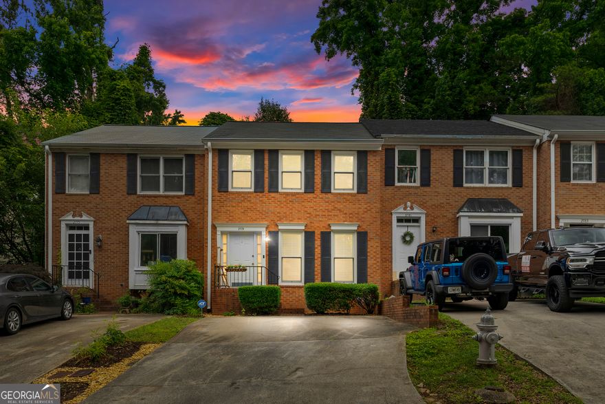 Welcome home to this beautifully updated 2 bed, 2.5 bath fee simple townhome, filled with natural light thanks to upgraded Andersen double pane windows and featuring a spacious, roommate friendly layout with double primaries on the second floor! You're welcomed by stunning hardwood floors and crown molding throughout the main level, which includes a grand entry foyer, dining room, kitchen, living room, half bath, and multiple storage closets; including convenient under stair storage. The heart of the home is the gorgeous kitchen, boasting granite countertops, under cabinet lighting, and soft close cabinets and drawers. Enjoy meals in the sun filled dining room or relax in the large living room with a gas starter fireplace. Step outside to your private, fenced courtyard featuring upgraded weather resistant composite decking and a charming stone wall. Upstairs, two generously sized primary suites each offer ensuite baths with granite, plus walk-in or his-and-hers closets; perfectly separated by a central laundry closet for convenience. With no HOA or rental restrictions, the thoughtful upgrades throughout, and a prime location within walking distance to Truist Park and The Battery, this East Cobb gem truly stands out!
