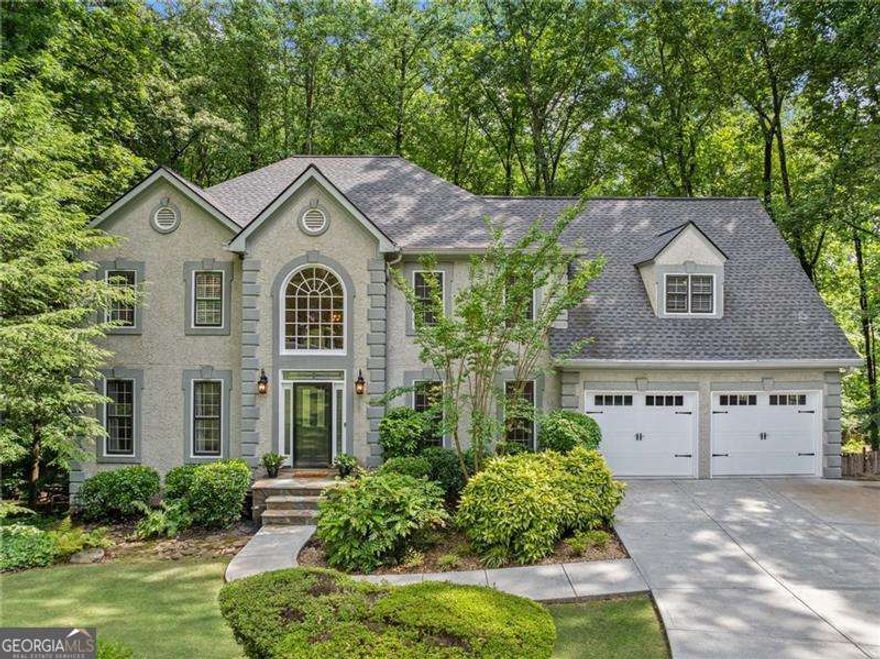 Beautiful and Elegant, Updated Home in One of East Cobb's Premier Swim/Tennis Communities - Windsor Oaks!    Experience the perfect blend of charm, comfort, and functionality in this beautifully maintained home, ideally located on a private cul-de-sac in one of one of East Cobb's most sought-after communities. With manicured landscaping, a new deck, and fresh interior and exterior paint, this home offers impressive curb appeal and welcoming spaces inside and out.    Enter through the grand two-story foyer featuring a dramatic wrought iron staircase, chandelier, and warm hardwood floors. The formal living room with French doors provides a quiet, versatile space-ideal for a home office or library.    The heart of the home is the spacious kitchen, thoughtfully designed with cherry cabinetry, granite countertops, stainless steel appliances, under-cabinet and recessed lighting, and an Electrolux induction cooktop, double ovens, and warming drawer. Gather around the large island or enjoy casual meals in the sun-drenched breakfast nook.    The adjoining family room with custom built-ins and a gas fireplace invites relaxation. Step into the expansive screened-in porch with a stunning stacked stone wood-burning fireplace, vaulted cedar ceiling, and serene wooded views-an ideal space for both everyday enjoyment and entertaining. The sunroom flows onto the newly built deck, perfect for grilling or relaxing, and the fenced backyard offers privacy and space to unwind.    Upstairs, the generous primary suite features hardwood floors and a tranquil spa-inspired bathroom with quartz countertops, heated tile floors, a freestanding soaking tub, frameless glass shower with rain showerhead, marble tile, a shower bench, and a custom walk-in closet. Four additional bedrooms and two stylish full baths provide room for family, guests, or flex use.    The finished terrace level includes a kitchenette, full bath, and private guest or teen suite with a separate walkout to its own deck-perfect for entertaining, multi-generational living, or game-day gatherings.    Enjoy access to top-rated schools and outstanding neighborhood amenities, including an Olympic-sized pool, lighted tennis courts, event pavilions, playground, and an active social calendar. This is more than just a house-it's a place to truly feel at home!