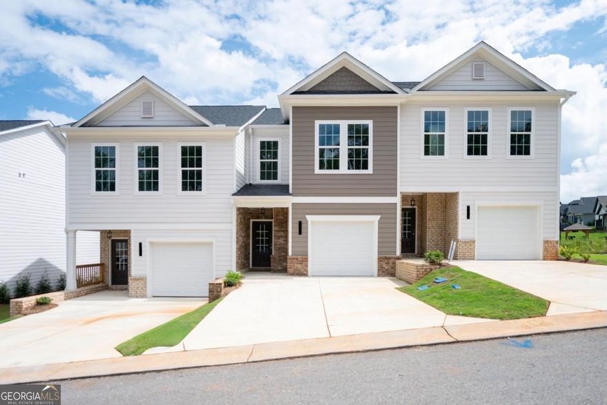 Welcome to your dream townhouse, our Nicole floorpan on Lot 1503 - where modern design meets golf course serenity! This 3-bedroom, 2.5-bath beauty offers 1,296 sq ft of stylish living space with soaring 9 ft ceilings both upstairs and down, filling every corner with light and openness. The main level features an inviting open-concept layout connecting the kitchen, dining, and living areas - ideal for entertaining or relaxed family living. A sleek electric fireplace with a tile surround extending to the ceiling adds a dramatic focal point and cozy ambiance.  The modern kitchen impresses with stainless steel appliances, granite countertops, a spacious island, and abundant storage - perfect for the home chef. Step through the sliding doors to a private back patio overlooking the lush green of the golf course - the perfect spot for your morning coffee or evening glass of wine. Upstairs, you'll find generously sized bedrooms and two full baths, designed for comfort and function.  Situated in a desirable golf course community, this home offers both scenic beauty and everyday convenience. Residents enjoy walking paths, manicured grounds, and a peaceful setting that feels like a getaway while still being close to everything. Shopping, dining, and entertainment options are just minutes away, along with quick access to major highways for easy commuting. Highly rated schools, local parks, and nearby recreation make this location perfect for professionals, families, or anyone seeking a balanced lifestyle.  With its modern finishes, open floor plan, and unbeatable golf course views, this townhouse is the perfect blend of sophistication and serenity. Don't miss your chance to make this exceptional property your next home!