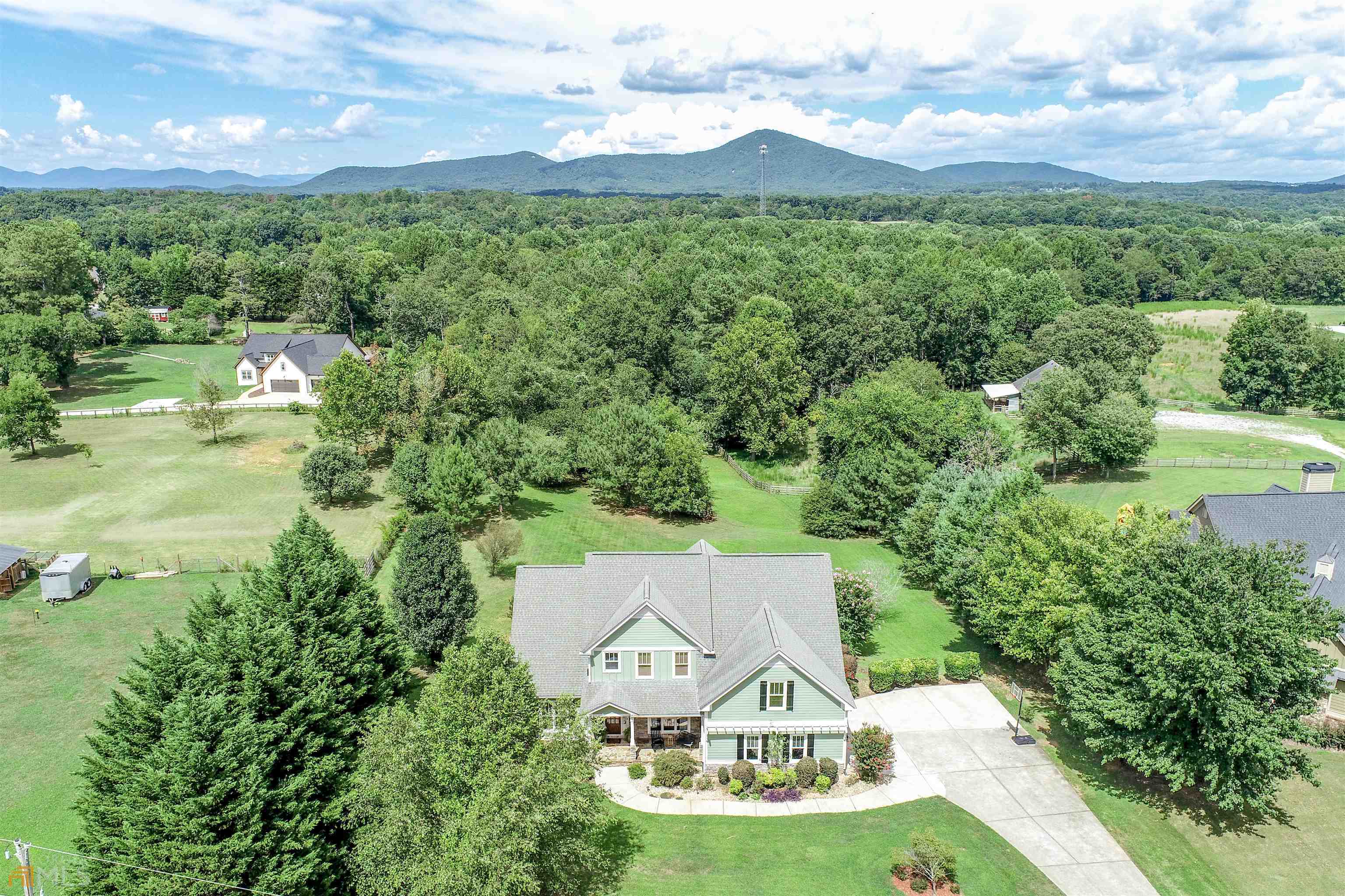 NEW PRICING. HIGHLY COVETED NORTH HALL SCHOOL DISTRICT. GREAT LOCATION - 5 MINUTES FROM NORTH HALL HIGH SCHOOL AND NO SUBDIVISION. Unreservedly beautiful area located just off Mt. Vernon Road surrounded by MOUNTAIN VEWS, HORSE STABLES and GRASSY pastures as far as the eye can see. This lovely home with CRAFTSMAN touches offers a highly desired layout that includes a COZY keeping room for reading or studying by the fire. Multiple seating areas make this a great kitchen for serving end of summer cocktails and appetizers. Extend the entertaining onto the deck with room to host the entire team for BACKYARD GAMES. LEVEL LOT front and back is ready to be transformed with your OUTDOOR LIVING dream design. TRANQUIL views from the master will have you soaking in a few extra moments with your morning coffee. If an art or theatre room is in your plans, the flex room upstairs would be the perfect GALLERY for your creations or big screen. WINDING DOWN the evening watching the sun disappear in a ROCKER on the porch is possible as you watch the pups play in the front. Plenty of room to plant your favorite annuals or bulbs or even grow a GARDEN. SOAK IN the last of the long summer days leading into fall with lots of FIREFLY chasing and undisturbed MOONLIT evenings in this part of the county.