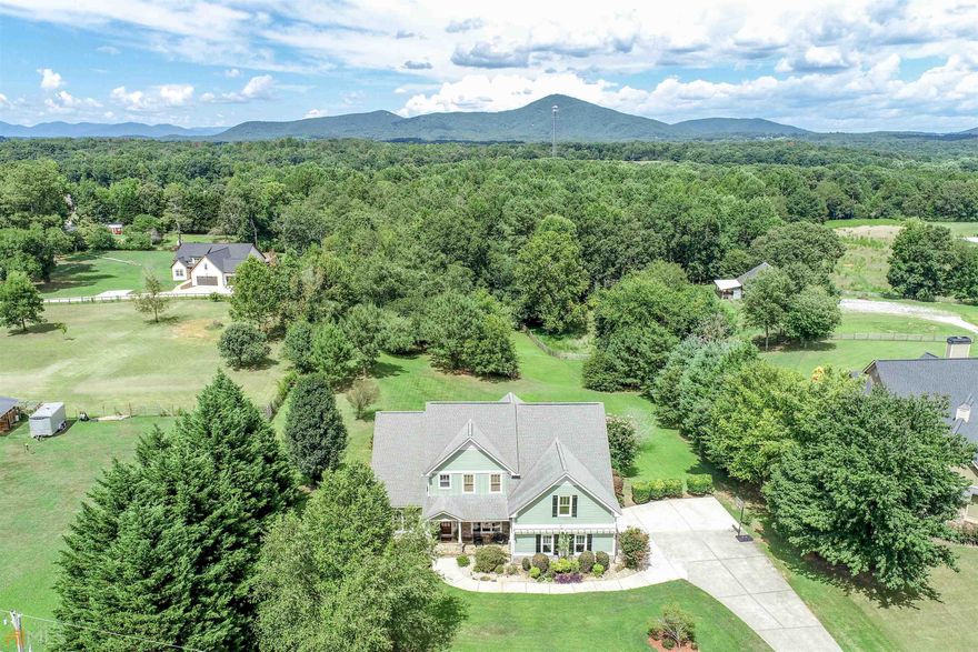NEW PRICING. HIGHLY COVETED NORTH HALL SCHOOL DISTRICT. GREAT LOCATION - 5 MINUTES FROM NORTH HALL HIGH SCHOOL AND NO SUBDIVISION. Unreservedly beautiful area located just off Mt. Vernon Road surrounded by MOUNTAIN VEWS, HORSE STABLES and GRASSY pastures as far as the eye can see. This lovely home with CRAFTSMAN touches offers a highly desired layout that includes a COZY keeping room for reading or studying by the fire. Multiple seating areas make this a great kitchen for serving end of summer cocktails and appetizers. Extend the entertaining onto the deck with room to host the entire team for BACKYARD GAMES. LEVEL LOT front and back is ready to be transformed with your OUTDOOR LIVING dream design. TRANQUIL views from the master will have you soaking in a few extra moments with your morning coffee. If an art or theatre room is in your plans, the flex room upstairs would be the perfect GALLERY for your creations or big screen. WINDING DOWN the evening watching the sun disappear in a ROCKER on the porch is possible as you watch the pups play in the front. Plenty of room to plant your favorite annuals or bulbs or even grow a GARDEN. SOAK IN the last of the long summer days leading into fall with lots of FIREFLY chasing and undisturbed MOONLIT evenings in this part of the county.