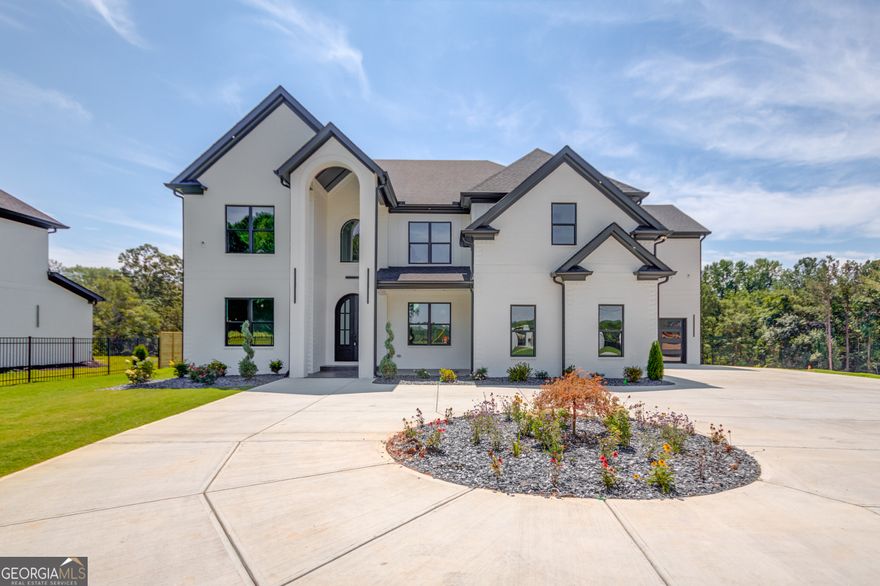 Nestled within a privately gated 2-acre expanse, this custom new construction home is a masterpiece of bespoke craftsmanship. Every corner whispers luxury with intricate tile and trim work adorning the interiors. The main floor unfolds to reveal a private office, formal dining room, and an exquisite chef's kitchen boasting stainless steel appliances, double quartz countertops, and a grand 48-inch gas range. Towering ceilings reaching 22 feet frame the living space where a striking fireplace and built-in cabinets create an ambiance of refined elegance. Step outside through glass doors onto the expansive back patio that overlooks the oasis-like backyardCoa canvas awaiting your personal touch for adding a pool or pool house. The oversized primary suite on the main floor offers respite in its opulent en-suite sanctuary. This secluded haven beckons you to unwind amidst unparalleled beauty while being just moments away from all modern conveniences. Venture upstairs to discover four additional generously sized bedrooms, each boasting private bathrooms for ultimate convenience. A secondary living room awaits above, offering flexibility and space for relaxation or entertainment in equal measure. This residence epitomizes modern luxury living at its finestCoan embodiment of refined taste and contemporary design. This home is in close proximity to downtown Buford, Chateau Elan, restaurants, shops, Mall of Georgia, Gwinnett Exchange with quick convent access to highway 85 and highway 985. ESTIMATED COMPLETION SEPTEMBER 2024. BASEMENT OPTION IS AVAIABLE AT THIS TIME- CURRENT LIST PRICE IS FOR SLAB.