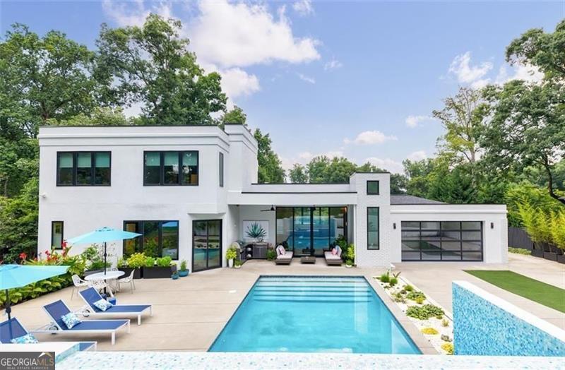 Luxury Lease Opportunity in LaVista Park: Modern Elegance with Resort-Style Living Experience elevated living in this exquisite Brookhaven residence, available for lease in the prestigious LaVista Park neighborhood-just minutes from downtown Atlanta, Emory University, the CDC, and Morningside. Designed for both sophistication and comfort, this modern home showcases an open-concept floor plan with soaring ceilings, a gourmet kitchen featuring high-end appliances, custom cabinetry, and a spacious island ideal for entertaining. The main-level primary suite offers a luxurious escape with his-and-her custom closets and a spa-like en suite bath complete with a standalone soaking tub, double vanities, and a walk-in shower. French doors open directly from the primary bedroom to your own private backyard oasis. An additional en suite bedroom on the main level provides privacy and flexibility-perfect for aging parents, guests, or a nursery. Upstairs, you'll find two more generously sized bedrooms, including one with its own en suite bathroom, ensuring plenty of space for family or visitors. The terrace level presents endless options with room for a media lounge, home gym, office, or hobby space-plus additional storage. Step outside to your resort-style backyard, where a sparkling pool, covered lanai, and fully equipped outdoor kitchen await. Accessible from both the great room and the primary suite, this outdoor retreat is ideal for relaxing or entertaining. A convenient poolside half bath adds to the thoughtful design. Additional features include a spacious mudroom with built-in storage and access to a gated rear-entry garage. This rare lease offering combines modern luxury with unbeatable location-close to parks, fine dining, and top-tier shopping-delivering a tranquil lifestyle just minutes from the vibrant heart of Atlanta. Don't miss your chance to lease this exceptional LaVista Park masterpiece. Schedule your private showing today