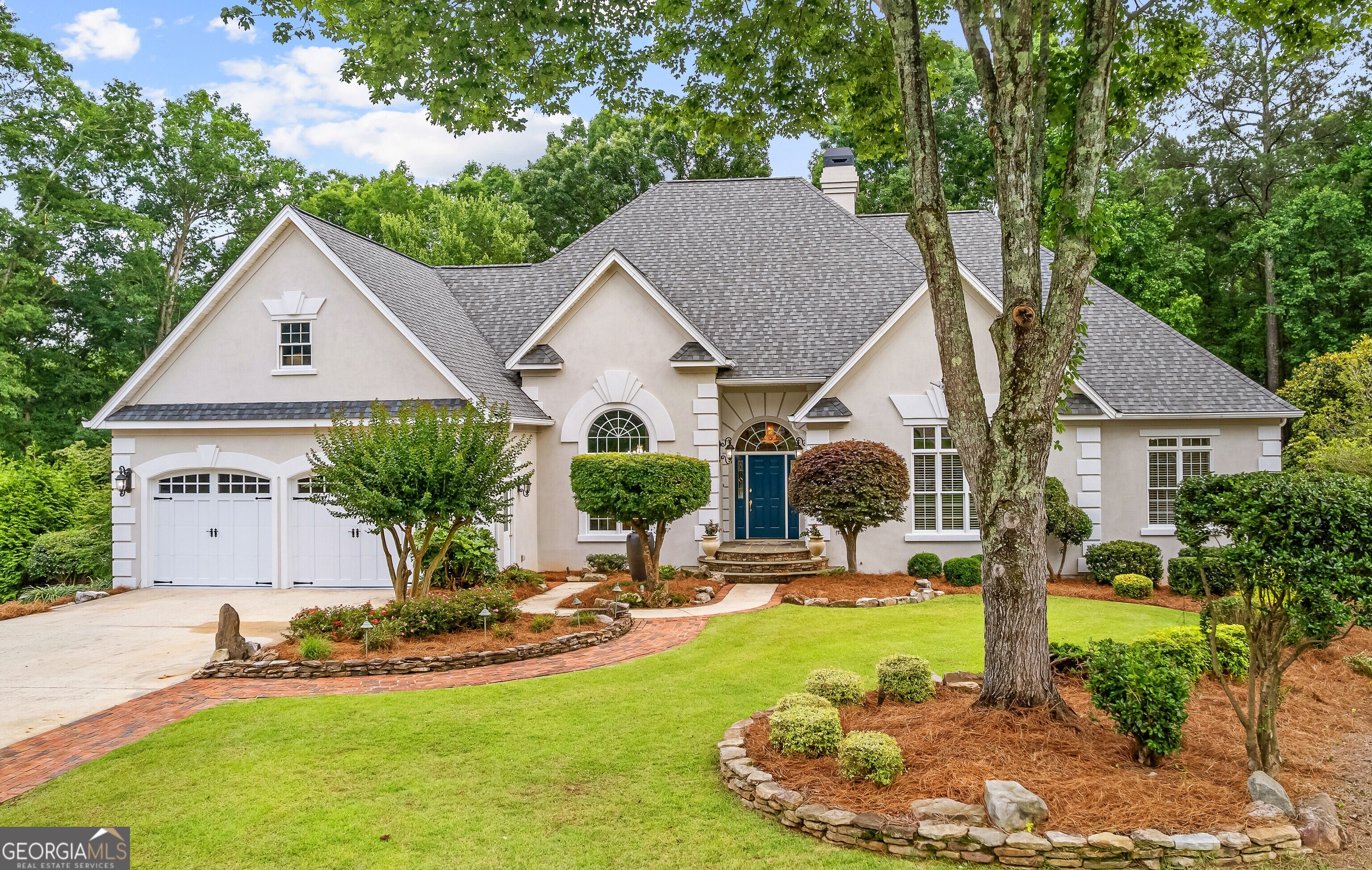 RARE FIND IN PEACHTREE CITY, CUSTOM BUILT RANCH WITH ELABORATELY FINISHED TERRACE LEVEL IN KEDRON VILLAGE ON A CUL-DE-SAC LOT AND A BEAUTIFUL YARD AND VIEWS!! Located in highly sought after McIntosh High School district. Roof was replaced December, 2023. Lots of natural light is provided by quality exteriorly aluminum clad windows. Low maintenance stucco exterior with aluminum trim and vinyl soffits. Primary bedroom and two ensuite bedrooms on main level. Primary bedroom has a large double octagonal trey ceiling. Large walk-in closets, primary closet includes custom built-ins. Twelve foot ceilings in foyer, living room and dining room. Dining room boasts a beautiful double octagonal trey ceiling soaring to approximately 14 feet. Large kitchen features center island and furniture quality custom cabinets containing deep drawers and handy pull-outs. Terrace level is exposed on 3 sides and is perfect for entertaining. It includes a fabulous custom bar appointments that include beautiful custom cabinetry, stainless appliances including a full size refrigerator, dishwasher, Hoshizaki nugget ice machine and a wine cooler. A pool table area is adjacent to the bar area and off of the large main living area. A large ensuite bedroom has a great view of back yard. A former exercise room could be transformed into a fifth bedroom with the addition of a window. Oversized golf cart garage provides additional storage area. Large workshop contains plenty of cabinets for tools and supplies and space for power tools. A corner room with lots of windows is suitable for an office, art studio, etc. All yard areas include extensive and lavishly improved components of professional landscape and hardscape designs including a salt water pool with large custom concrete surface area, a large waterfall and a fire pit area, stone/paver walkways and retaining walls all with a picturesque view of an adjacent neighborhood pond. Attic access is a breeze with a nice wide stairway leading to approximately 500 sq ft of floored space. This property is agent owned. Qualified buyers only please.