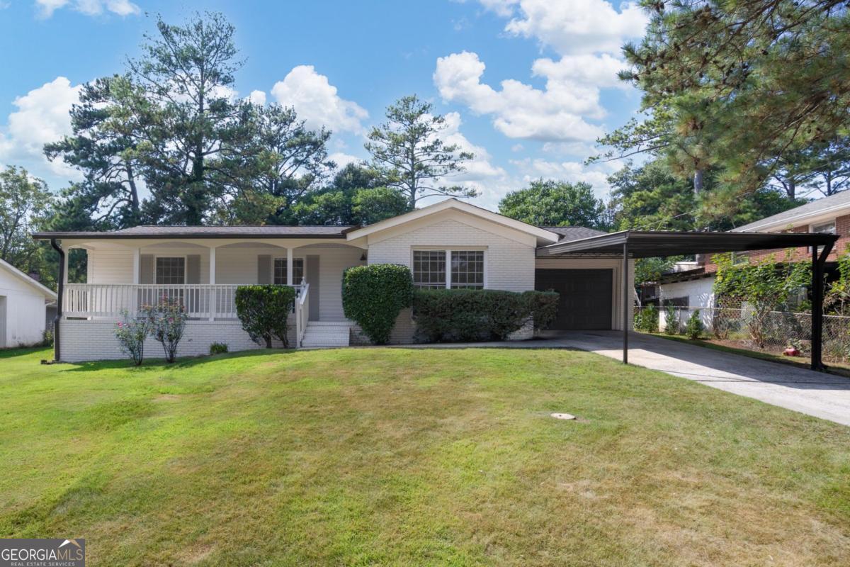 Don't miss your chance to get this beautifully renovated, Cobb County home for an amazing price! Conveniently located right in the middle of Cobb, you will be the envy of all your friends. The newly painted exterior is virtually maintenance free with a brick and vinyl sided exterior. The covered front porch is perfect for sitting and drinking your morning coffee or enjoying the evenings. As you enter the front door, you are set to impress your guests with the real solid oak hardwoods throughout. Large energy efficient windows allow all the light to fill the rooms. The brand new eat-in kitchen boasts stainless appliances, modern finishes, new upgraded cabinets, and quartz countertops. Make your way through the home to the best feature, the owner's suite! With a double vanity, modern lighting and plumbing fixtures, and a huge walk-in shower, you will not be disappointed with this space. You even have a large walk-in closet! There are two beautiful secondary bedrooms that share another wonderfully updated bathroom with tiled tub surround and updated vanity and fixtures. Step out back and find a new deck in the large, flat, fenced yard. There is even a new roof and new garage door and opener. This one really is move-in ready and waiting for you.