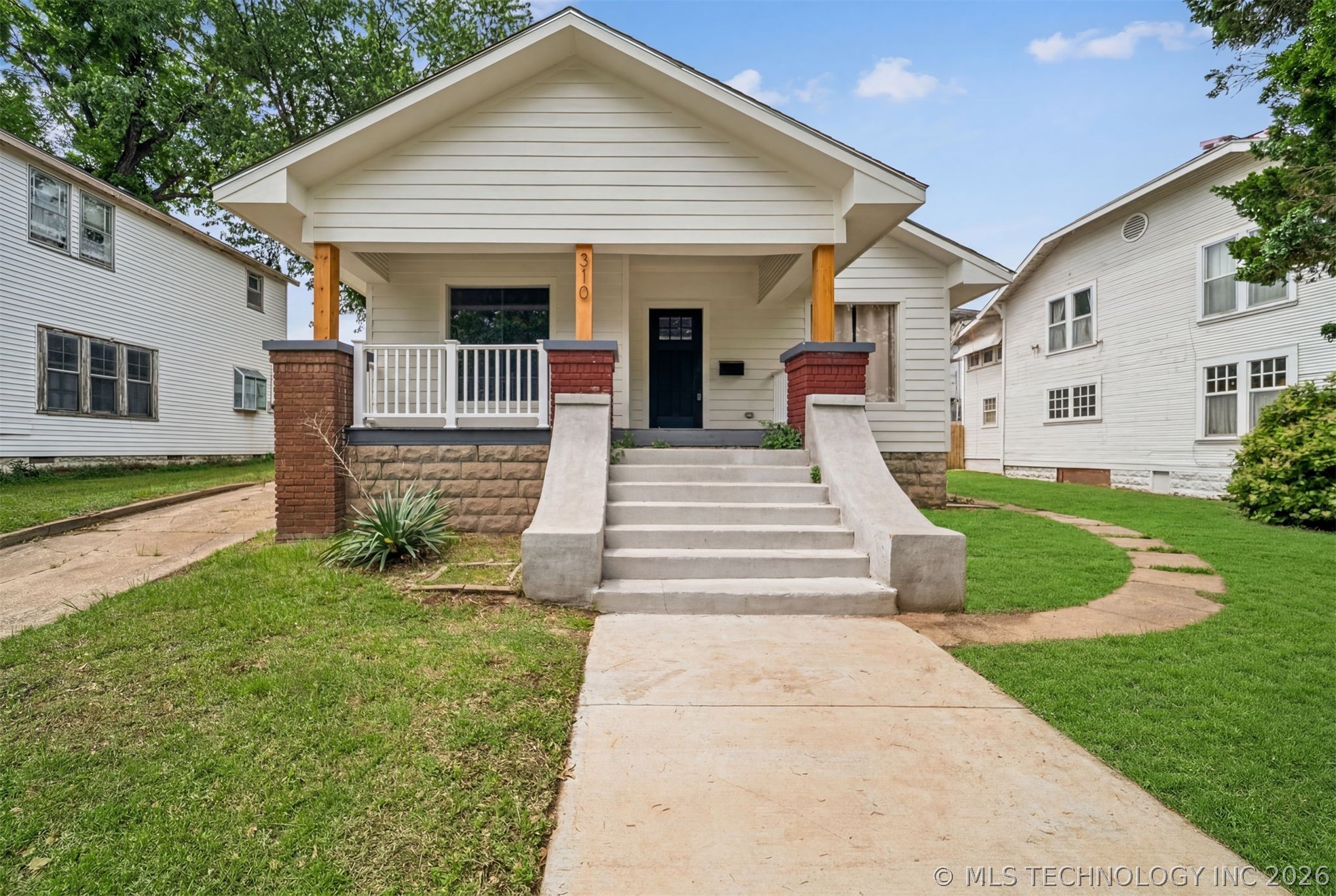 Craftsman-style facade featuring white siding, a c