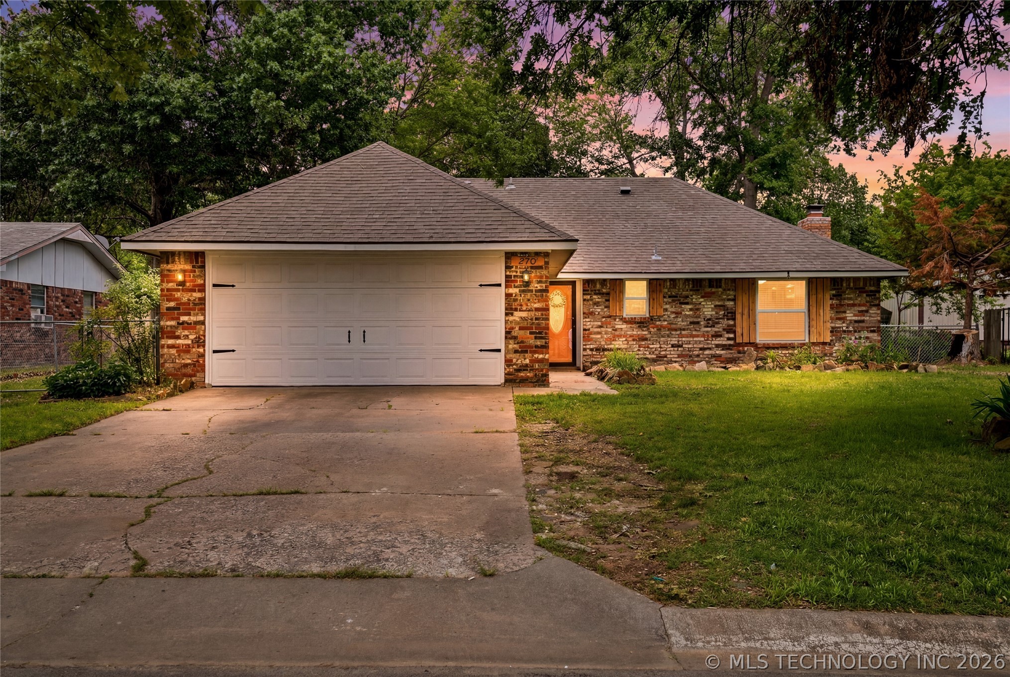 Brick exterior with a prominent two-car garage