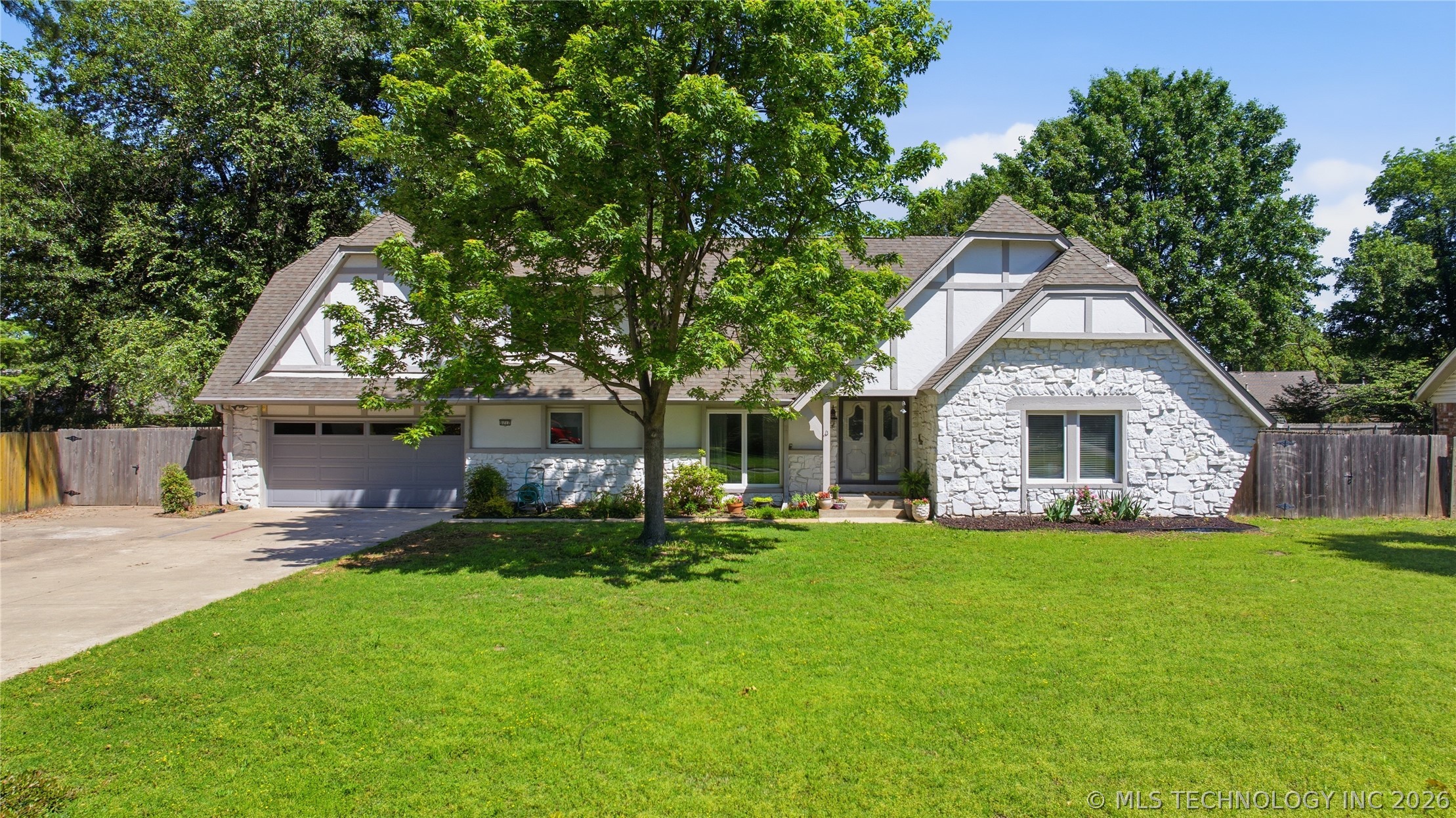 Stone and siding exterior featuring a multi-gabled