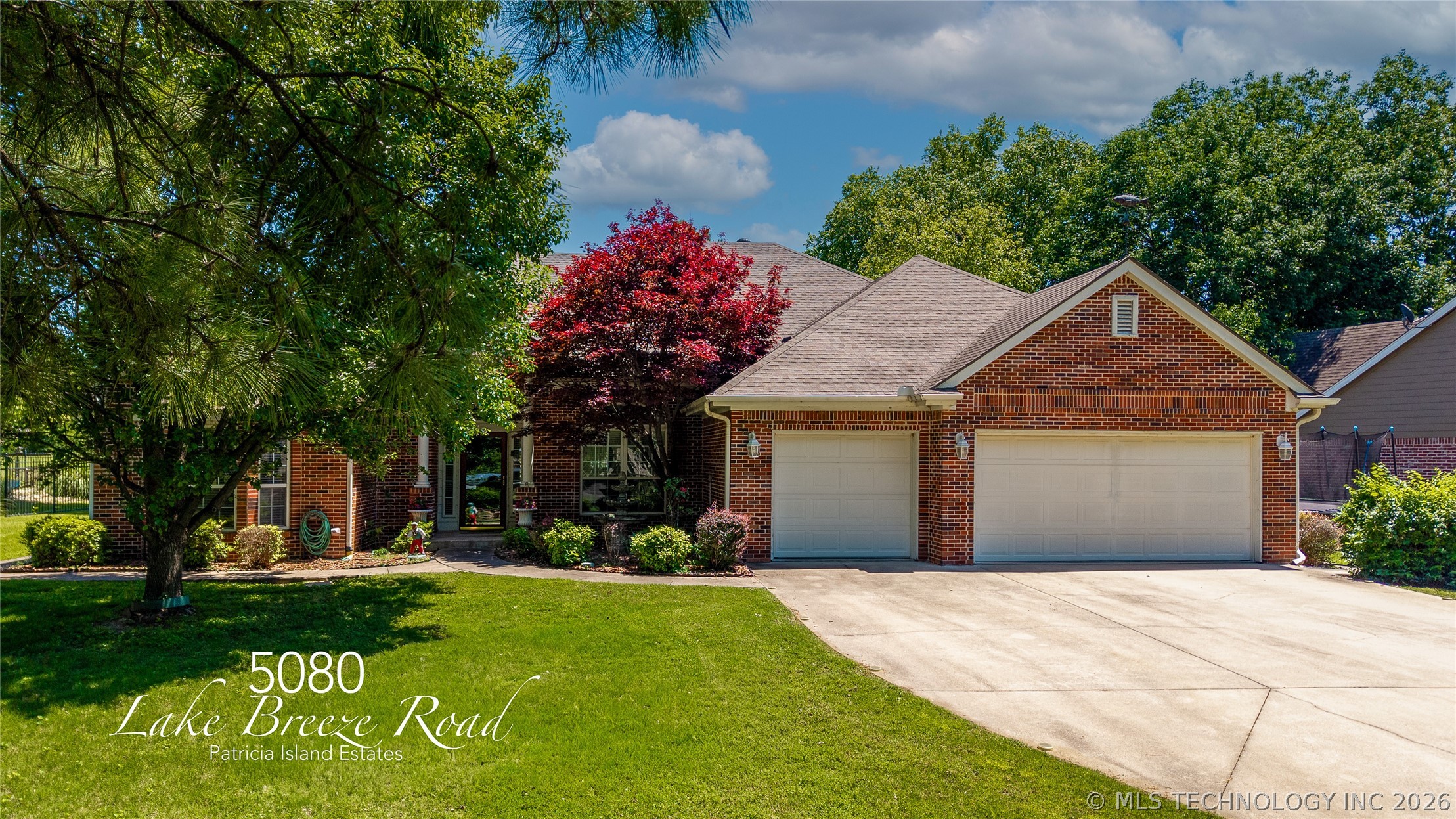 Brick exterior featuring a 3-car garage, concrete