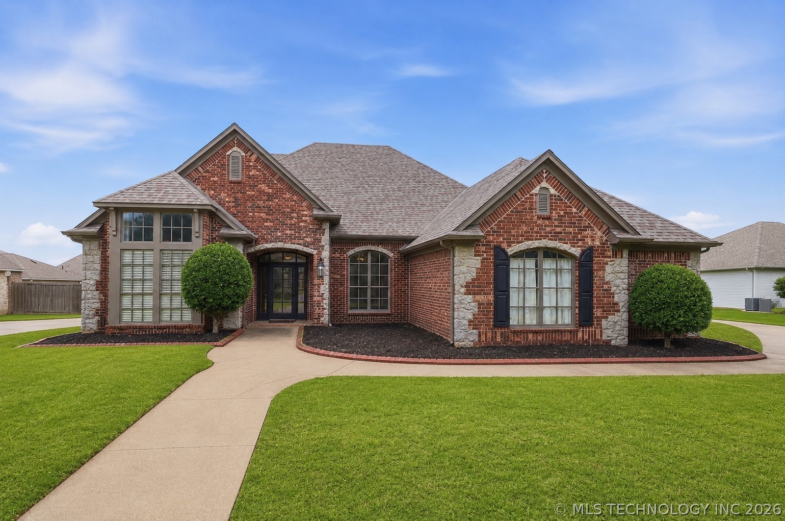 Brick and stone exterior featuring multiple gables