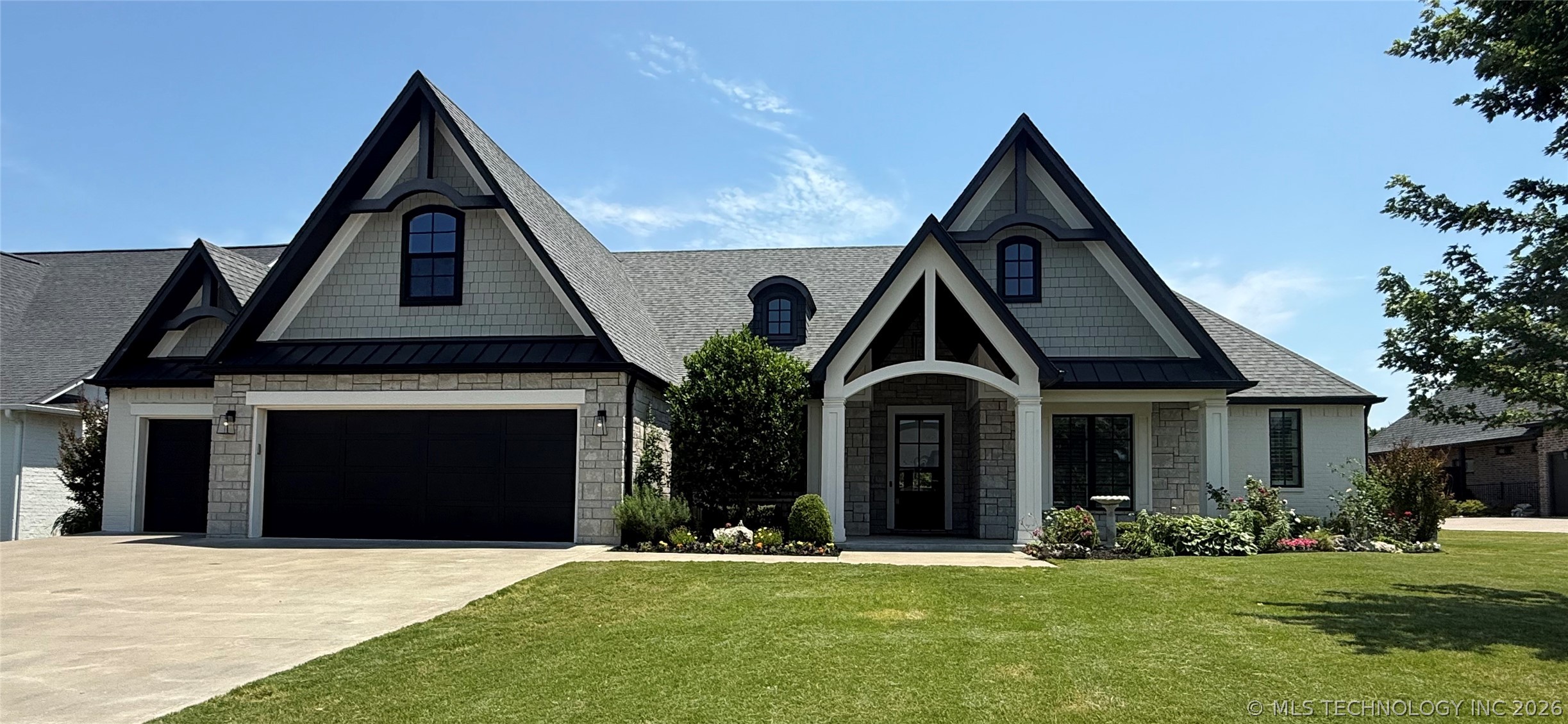 Modern Tudor-style home featuring a prominent gabl