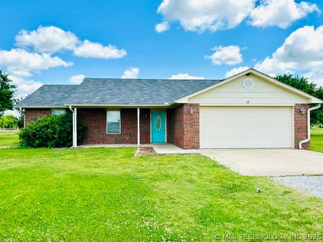 Brick exterior with a prominent garage, covered fr