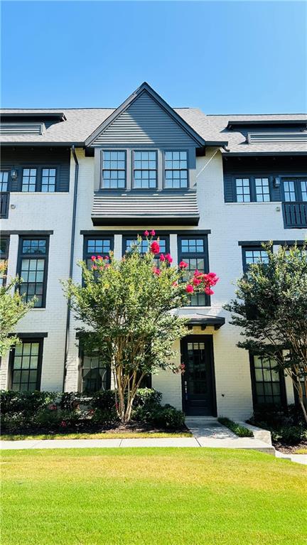 Welcome to this luxury townhouse, An opportunity to reside within a distinguished community in bustling Metro Atlanta. this townhome extends an oasis of living, granting both space and seclusion for your personal and professional endeavors, all while resting a mere heartbeat away from the Aria Village Restaurant & Shopping. Upon entering, a cozy bedroom and full bath grace the first floor, affording privacy that proves equally fitting for guests or for use as an office space. Ascend to the second level, where a grand expanse unveils itself, crowned by 10-foot ceilings, housing a harmonious mix of dining and living space. High interior doors and large-scale windows that allow for an immense amount of natural light. Here, a sprawling quartz countertop island beckons, where you can cook and enjoy meals with your loved ones, while nearby, the dining enclave stands ready to host meals with family and friends. You can also step out to the balcony and enjoy your favorite beverage. The master bedroom provides plenty of light throughout the day, with a large bathroom, complete with a roomy shower. Nestled within easy reach of GA 400, this community effortlessly bridges the northern suburbs and the heart of the city. With the explosive growth of Metro Atlanta, The location is in the highly sought after Aria South, which will have its own community pool and is conveniently located within walking distance to the Alastair Village! Enjoy a low-maintenance lifestyle within this popular Live-Work-Play community! Awesome Location, it's just minutes from all major highways G400 and 285, minutes to Whole Food, Starbucks, Publix and tons of restaurants, shops, and parks!