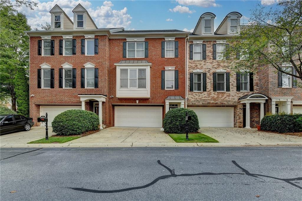 Located in the desirable Vinings Estates, this exquisite 3-bedroom, 2.5-bathroom townhome offers an ideal blend of elegance, comfort, and convenience. The grand two-story foyer creates a welcoming atmosphere, setting the tone for the spacious and light-filled interior. Hardwood floors throughout the main level enhance the sense of elegance. The living room features a cozy fireplace with built-in shelving and expansive windows overlooking the serene park. The gourmet kitchen combines style and functionality with white cabinetry, a spacious island featuring a gas cooktop and seating, stone backsplash, and solid surface countertops. A breakfast area is conveniently located off the kitchen. A large separate dining room is perfect for entertaining or can serve as a home office. The upstairs primary suite is a serene retreat, complete with a vaulted ceiling in the bathroom, dual sinks, granite countertops, an oversized shower, and a Jacuzzi bath. The primary bedroom includes a walk-in closet. A second upstairs bedroom features an ensuite bathroom, ideal for family or guests. The third bedroom, situated in the lower level, offers versatility as a guest suite, home office, or gym. A large deck off the main level is perfect for outdoor activities. The HOA handles landscaping and grass care, freeing up weekend time. Community amenities include two clubhouses, three pools with a water slide, two fitness centers, tennis, pickleball, and walking trails. The location provides easy access to major highways and local attractions.
More Pictures coming.