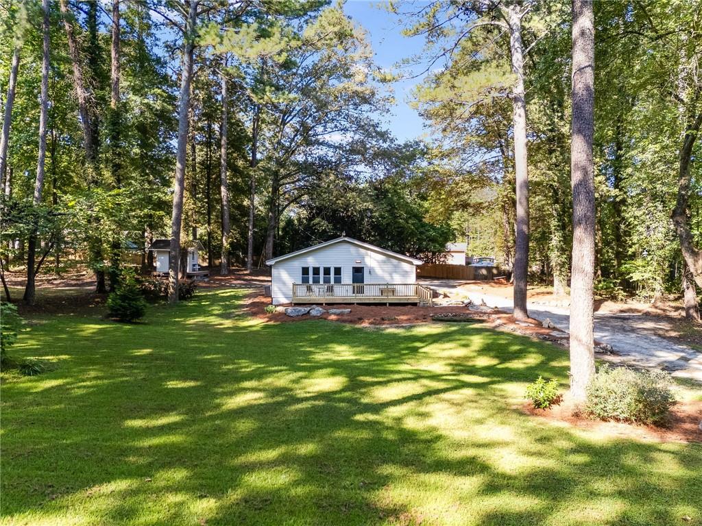 If you're looking for an updated home that has been done with care, attention to detail and functionality in mind than look no further! On 1.21 acres this house has so many opportunities that come with it, all that's missing is someone to make it their own. The freshly built front deck is a nice place to sit and watch the cars go by or enjoy a drink and enjoy nature. Walking in you'll see newly added LVP flooring that goes well with the style of the house, the large living room is the perfect place to entertain or to just relax and watch tv by the fireplace. The isolated master suite has nice privacy and features a double vanity along with a tiled shower and a walk-in closet. The common area is well connected to the eat-in kitchen and the 2nd full bathroom, along with the 2nd and 3rd bedroom. The kitchen features a granite counter top and new cabinets for lots of storage and a large island for eating. A farm style sink and garbage disposal along with all stainless steel and electric appliances making cooking a joy. So many more things to be excited for in this house, such as, all new lighting, new A/C unit, drop down attic access, paved rear patio, new washer/dryer combo, and a fully finished work shed. All that this home in missing is someone to make it theirs.