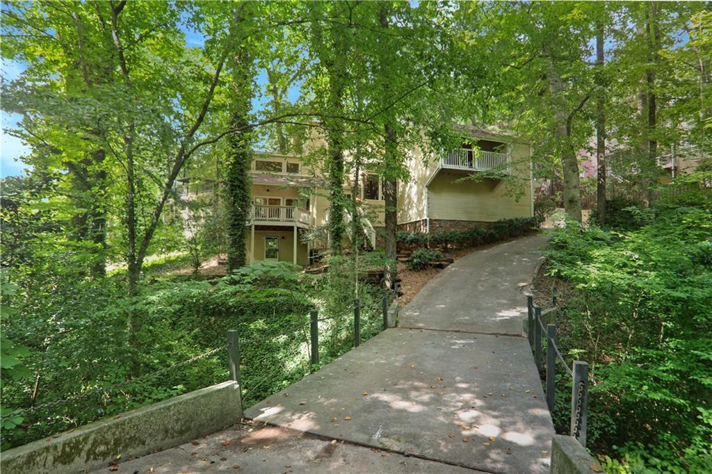 Tucked away on a quiet cul-de-sac in one of Atlanta’s most desirable neighborhoods, this unique property offers a rare opportunity to create your dream home in a truly special setting. Overlooking a serene creek and nestled among mature trees, you’ll feel like you’re living in a treehouse in the heart of the city. This home offers 4 bedrooms and 2 full baths/2 half baths with great bones and a layout full of potential. Whether you're dreaming of a full renovation or a creative refresh, this is your chance to craft something spectacular in a picture-perfect location. Nature lovers and bird watchers will appreciate the peaceful sights and sounds of deer and wildlife. Bring your contractor and your vision — this property is ready to be transformed into a modern masterpiece or a cozy, wooded sanctuary. Located just minutes from Town Brookhaven, top-tier schools, shopping, dining, parks, and major highways, 1255 Old Woodbine Rd offers the best of both worlds: the tranquility of nature with the convenience of city living.