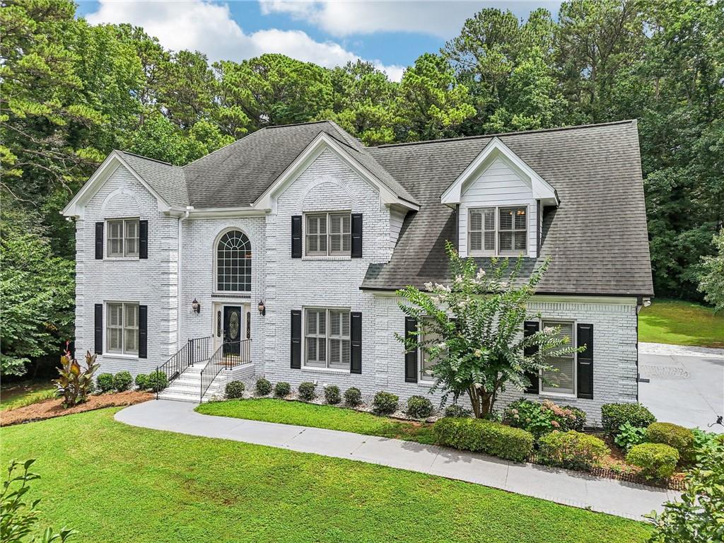 Welcome to this spacious and versatile home offering privacy, flexible living spaces, and no HOA. Tucked away at the end of a long private driveway, this peaceful retreat is surrounded by trees, providing a serene, wooded setting. This four-sided brick exterior gives the home timeless curb appeal, and the freshly painted interior provides a clean, move-in-ready feel.
Inside, a two-story foyer opens to a large formal living room and a separate formal dining room ideal for gatherings. The main level features hardwood floors, tall ceilings, and expansive windows that fill the home with natural light. The living room centers around a fireplace and opens to the kitchen and breakfast nook. The open concept kitchen includes granite countertops and plenty of cabinet storage, while a large sunroom with hardwood floors and surrounding windows offers a bright and comfortable space for casual dining or relaxation. A door from the sunroom leads directly to the back deck, creating a seamless indoor-outdoor flow. The main level includes a bedroom and a nearby full bathroom, perfect for accommodating guests. The laundry room is also on this level and includes a utility sink along with its own exterior entrance.
Upstairs, you’ll find four bedrooms, including an oversized primary suite with a sitting area, separate dual vanities, a walk-in shower, and a soaking tub. Two of the secondary bedrooms share a well-designed Jack-and-Jill bathroom, each with private vanity areas separated from the shared bathing space. The fourth bedroom, located near the primary suite, is ideal for a home office, nursery, or hobby room.
The terrace level offers excellent flexibility, featuring its own private entrance, a bedroom, full bathroom, living area, a small kitchenette with a sink, and laminate flooring—making it ideal for multi-generational living or rental potential. This level opens to a side-patio and a private backyard surrounded by trees. A fully concrete safe room reinforced with metal bars offers reliable storm protection and secure storage.
The backyard offers a peaceful setting with usable space and natural privacy. Whether you're enjoying coffee in the sunroom, dining on the back deck, or relaxing on the terrace-level patio, this home provides comfortable spaces for everyday living and entertaining.
Conveniently located just off Lawrenceville Highway with seamless access to I-85, this home blends the tranquility of its wooded, private setting with the convenience of modern living. Situated in the sought-after Parkview School District, it offers an ideal balance of lifestyle and location. Outdoor enthusiasts will appreciate being moments away from Lilburn City Park—with its splash pad, playground, picnic pavilions, and connection to the 4.2-mile Camp Creek Greenway trail—and Lions Club Park. For shopping and entertainment, you're just minutes from Lilburn Square and Plaza Las Americas, as well as Sugarloaf Mills in nearby Lawrenceville.