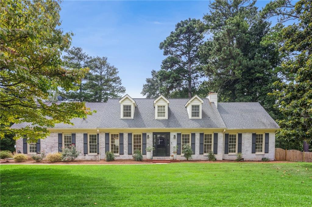 This beautifully renovated Cape Cod-style home offers the perfect blend of charm and modern updates. The spacious owner’s suite on the main level features a stunningly remodeled bathroom — an inviting retreat to unwind after a long day. Nestled in a highly sought-after East Cobb neighborhood, you’ll enjoy top-rated schools and fantastic amenities, including a pool, tennis courts, and playground. The brand-new kitchen boasts new appliances, elegant stone countertops, and custom cabinetry, opening into a bright enclosed sunroom — the perfect spot for a breakfast nook, morning coffee, or a cozy reading corner with a glass of wine. Hardwood floors run throughout the home, complementing the thoughtful updates. Upstairs, you’ll find two bedrooms and a renovated full bath, along with a spacious Bonus room with its own private staircase — ideal for a fourth bedroom, office, gym, or playroom. Step outside to your fully fenced backyard with an extended patio and deck, perfect for entertaining or quiet evenings under the stars. With wonderful neighbors and an active community, this home offers not only comfort and style but also long-term value — making it a place you’ll be proud to call your forever home. Don’t miss this rare opportunity in East Cobb!