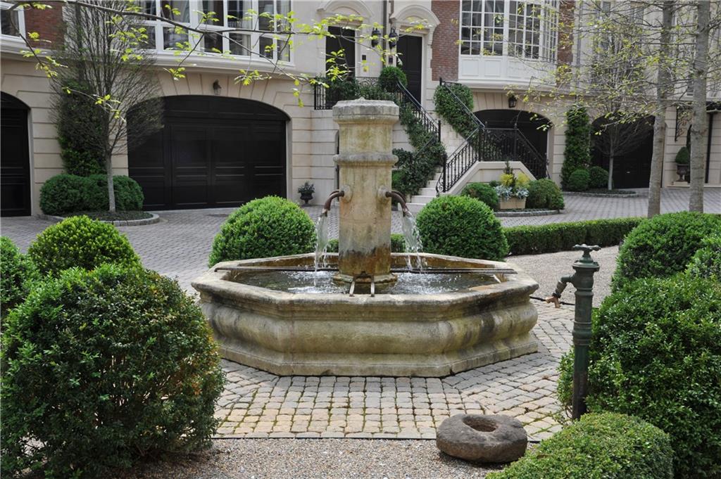 This is an incredible fee simple townhome with 12' ceilings on main. So much space with over-sized private courtyard. Formal Room w/ 16' ceilings, his & her bathrooms, 2 refrigerators in kitchen, 4 car garage. Property is one of 17 homes on approx 5 acre secluded site with 3+ acre private park. Only home available.