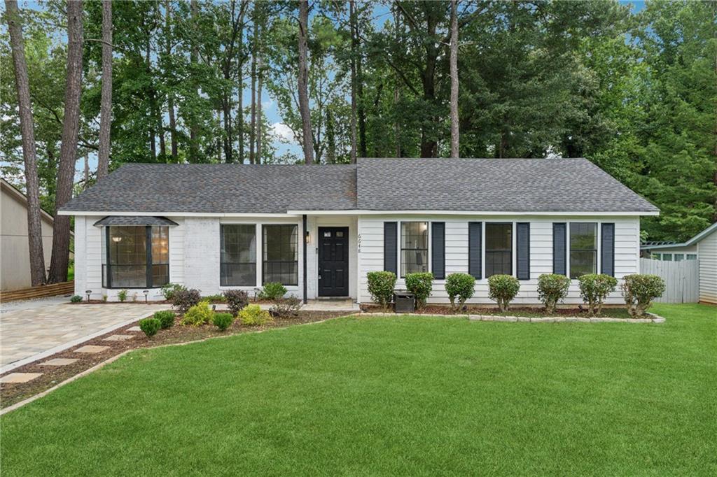 Look no further, welcome to this beautifully updated 4-bedroom, 2-bathroom Ranch style home. As you walk up to the front door make sure to note the exquisitely done paver driveway! This home offers the perfect blend of location and lifestyle. This fully renovated home has been impeccably reimagined for a new homeowner to make it their own. The kitchen features upgrades to make it a true focal point, featuring striking cabinetry, solid wood countertops, and sleek appliances — ideal for entertaining and everyday living. Walk into the living room that features Vaulted Ceilings and a space with plenty of natural light. A spacious primary bathroom offers an expansive shower and modern finishes. Enjoy serene outdoor living in your huge, landscaped yard that comes complete with a fire pit. Backyard is fenced in to add to the privacy the lot offers. With easy access to the shopping, dining, and entertainment near Atlanta (I-20 is 2 mins away), this home offers both tranquility and convenience. Truly move-in ready — modern, comfort, and location all in one. This home is waiting for you to make it yours!