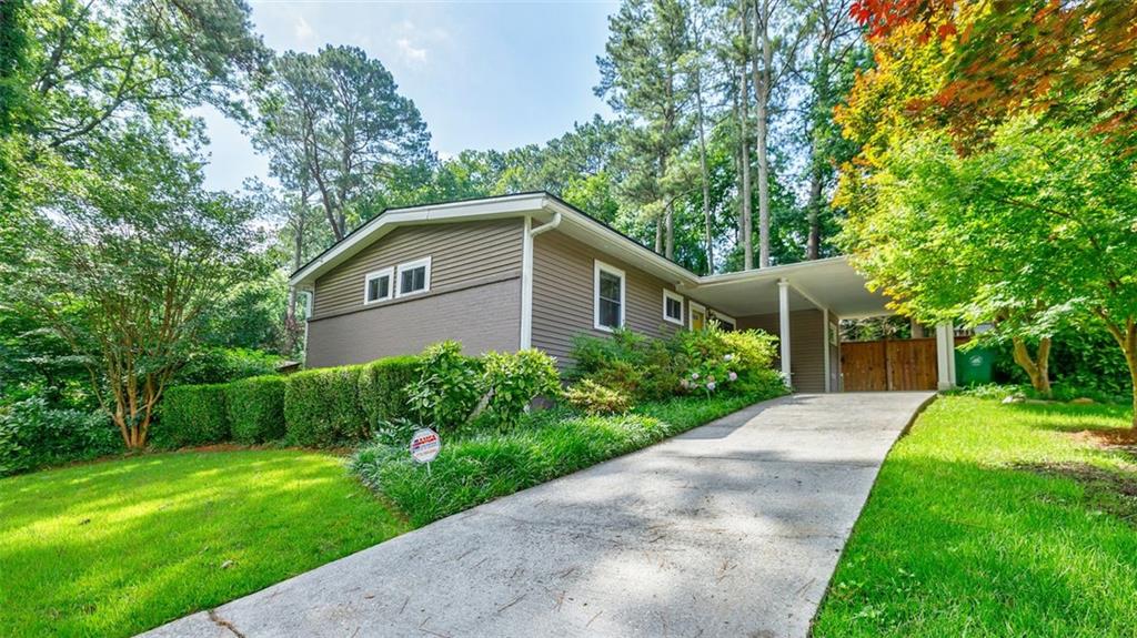 This lovely mid-century modern ranch home is Move-In Ready! Sitting back from the street in this quiet well located neighborhood this home provides a peaceful refuge. Featuring an open floor plan with the dining area just off the living room and renovated kitchen it’s an easy home for entertaining friends and family. Beautiful warm hardwood floors throughout the home with tile in the bath. Plenty of room for guests and an office or music room for remote workers and artists. Add the lush, fenced backyard with a patio for grilling and a perfect area for a fire pit for hanging out with friends and you'll feel far away from the nearby city. There are also raised bed gardens for growing your own veggies and flowers and an outdoor shed for your garden tools and other storage needs. A bike storage tent/unit is included for easy access to your bikes to take a ride. Covered parking in your carport and plenty of extra parking in the driveway. Excellent location without high city taxes as it's in unincorporated Dekalb where you're close to downtown Decatur, Emory University, Emory Hospitals and only 5 minutes away from the redevelopment of former North Dekalb Mall into the exciting new Lulah Hills which will have restaurant and retail space. Highway access not too far with 78 about a mile away. Don't delay in seeing this perfect house so you can make it your new home!!