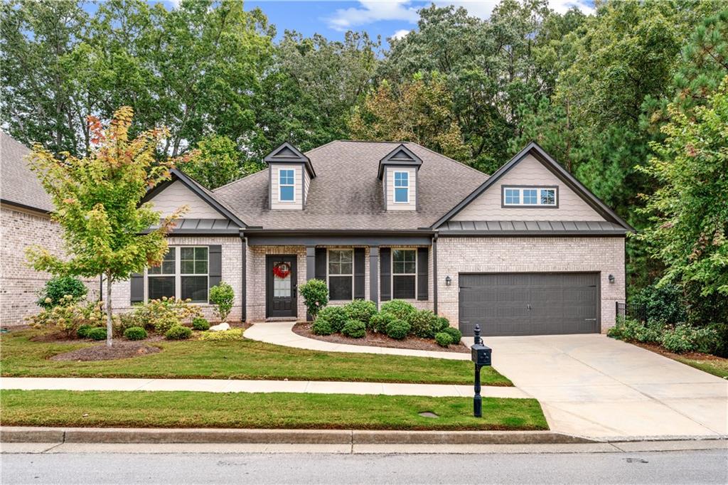 WELCOME TO THIS STUNNING MODERN RANCH-STYLE HOME located in the highly desirable Preserve at Hamilton Mill, a quiet, elegant neighborhood where all homes feature 4-SIDE BRICK construction, and within the STEM Seckinger High School district. This four-sided brick beauty offers both elegance and privacy, surrounded by lush green trees along the side and backyard—creating a serene view that becomes even more breathtaking with vibrant fall foliage.
As you enter, you’ll be greeted by a wide foyer flanked by spacious formal living and dining rooms. Though built only six years ago, this home feels almost brand new. The open-concept main living area features 11-foot ceilings, hardwood flooring throughout the entire main level, including the master bedroom, and a cozy fireplace with a floating mantle and tile surround.
The chef’s kitchen is a true showpiece with 42" white cabinets, white quartz countertops, stainless steel appliances, and a modern weathered wood-look tile backsplash that adds warmth and character. The split cooking design includes a wall-mounted oven and microwave with a separate gas cooktop and vent hood vented to the outside.
The split-bedroom layout offers two secondary bedrooms with a full bath between them—one featuring a versatile queen-size Murphy bed. The spacious master suite includes a double vanity, a beautifully tiled shower with a bench, and a large walk-in closet.
Fantastic location—just 5 minutes to I-85 (Exit 118), 10 minutes to Northside Hospital Gwinnett, and close to Seckinger High School, Mall of Georgia, Costco, Sam’s Club, and more! Just 5 minutes from Bogan Park and only 15 minutes to the scenic Mulberry Park with a large lake—perfect for outdoor activities! There’s a great golf course located just 10 minutes away. Easy maintenance with lawn care included with HOA dues.
Don't miss the opportunity to make this stunning house your forever home!