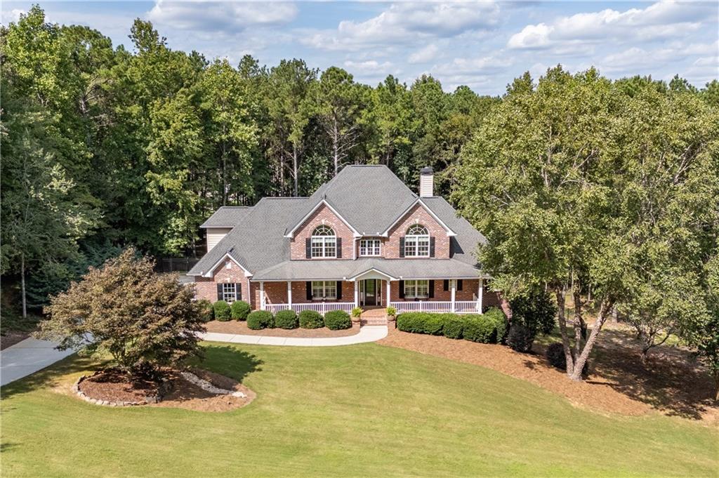 Welcome to Southern Elegance in Antrim Glen..... Experience the comfort and warmth of the South in this casually elegant custom home, perfectly set on 2.03 acres in the prestigious estate community of Antrim Glen. A classic rocking chair front porch welcomes you in, while the backyard unveils a BRAND NEW GUNITE SALTWATER POOL AND SPA-your own private resort. Inside, hardwood floors flow throughout the main living areas, complemented by FRESH PAINT THROUGHOUT, PLANTATION SHUTTERS , and crown molding. Just off the entry, an office with French doors overlooks the front porch, while the dining room-also open to the kitchen and also facing the porch-offers a bright and welcoming space for entertaining. The gourmet chef's kitchen features granite countertops, high-end appliances, custom cabinetry, and abundant storage. Natural light fills every room, especially the vaulted great room with its COFFERED CEILING and WALL OF WINDOWS framing the pool oasis. The main-level primary suite offers his-and-hers closets, a SOAKING TUB and a STEAM SHOWER for the ultimate retreat. French doors extend the living space onto a deck with wooded privacy and wildlife views. It's the perfect spot for a peaceful morning coffee as the sun reflects off the pool, or to unwind at day's end. Upstairs, three spacious bedrooms with NEW CARPET, two full baths, and a bonus room with NEW LUXURY VINYL PLANK flooring provide incredible flexibility-ideal for kids, grandkids, visiting guests, or even a craft room, playroom, or home library. The terrace level is a true extension of the home-a COMPLETE PRIVATE LIVING SPACE with a full kitchen, bedroom, bath, half-bath for guests, laundry hookup, separate entry, and DIRECT POOL ACCESS. Perfect for MULTIGENERATIONAL LIVING, this level offers privacy while keeping loved ones close. A huge family room anchors this level and can be closed off with French doors, creating the perfect gathering space or private retreat. With abundant storage and two safe rooms, this home offers comfort, luxury, and peace of mind. This exceptional property blends casual Southern charm with refined elegance-where natural light, thoughtful design, and resort-style living come together beautifully. If you're seeking a WELL-BUILT CUSTOM HOME in your own private corner of the world-yet just minutes from area conveniences-this is the one. Don't miss the opportunity to experience a meticulously maintained property that is truly move-in ready.