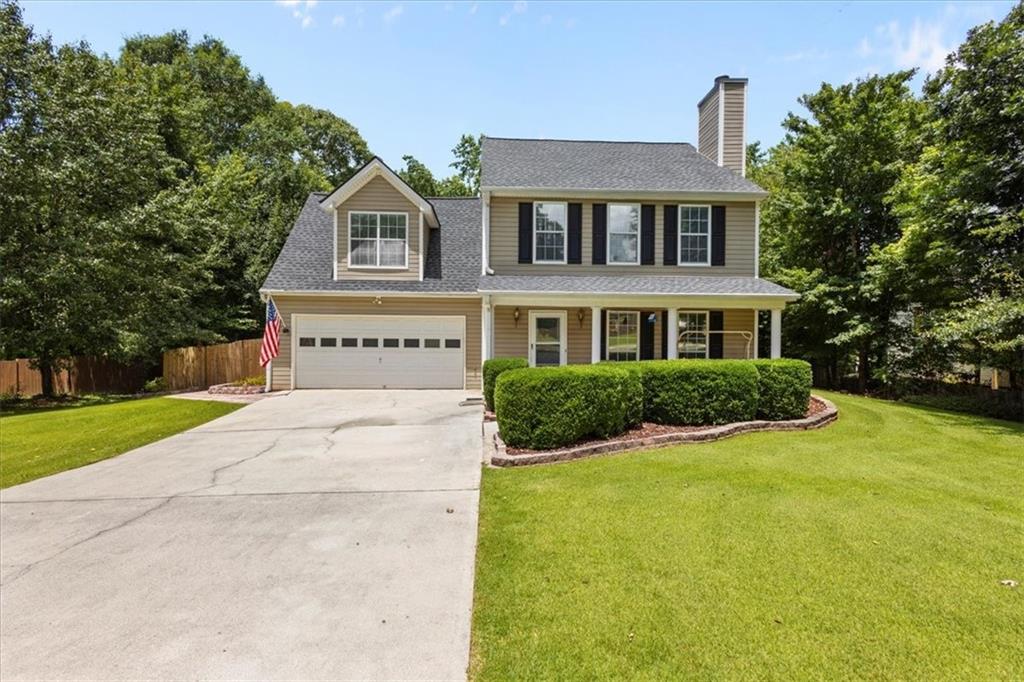 Welcome Home to This Spacious Two-Story Traditional—A Landscaper's Dream! Nestled on a quiet street, this beautifully maintained home boasts upgraded zoysia grass and a lush, private fenced backyard—perfect for outdoor living and entertaining. Step inside to find an oversized family room featuring a stunning stacked stone fireplace, perfect for cozy evenings. A large separate dining room offers plenty of space for hosting family and friends. The chef-inspired kitchen includes stainless steel appliances, a brand-new gas stove with a double oven. Upstairs, the generously sized master suite offers a serene retreat, complete with a luxurious en-suite bathroom, separate tub and shower, and a huge walk-in closet. Two additional spacious bedrooms share a well-appointed hall bath, while an oversized bonus/4th bedroom provides endless options—think guest room, office, playroom, or home gym. Enjoy morning coffee on the rocking chair front porch, or unwind on the custom-built patio, perfect for entertaining or relaxing in your private outdoor oasis. Extras include: refrigerator, washer, dryer, garage fridge, and deep freezer—all staying with the home! Conveniently located near I-20, with quick access to shopping, dining, and entertainment, this home offers the perfect blend of comfort, style, and location. Don’t miss this exceptional opportunity—schedule your showing today!