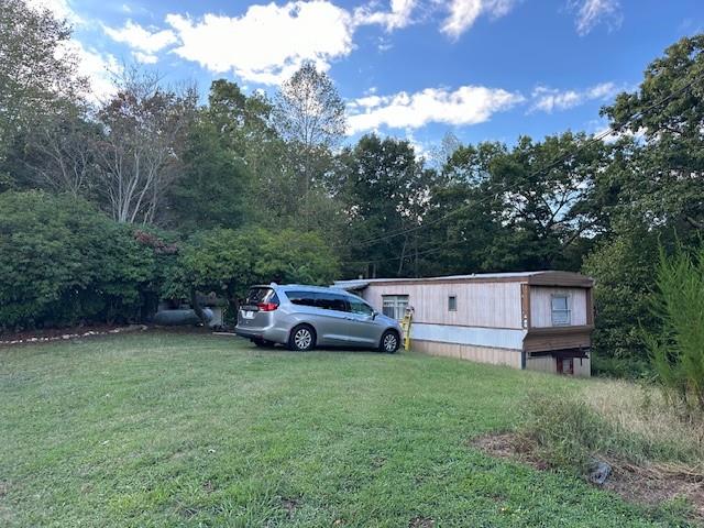 This is a 2 bedroom 2 bathroom property settled in the foothills of Dahlonega, Georgia. The downtown center and schools are a short drive away. Open concept living at its best. Spacious master with accommodating ensuite bathroom. Back deck with mountain views for outdoor living. Room to roam in the lovely front yard. Large windows bring in plenty of natural light. Clean and bright kitchen outfitted with stained wood cabinets, gas range, and fridge. Has multiple storage sheds on property that are part of the rental.
