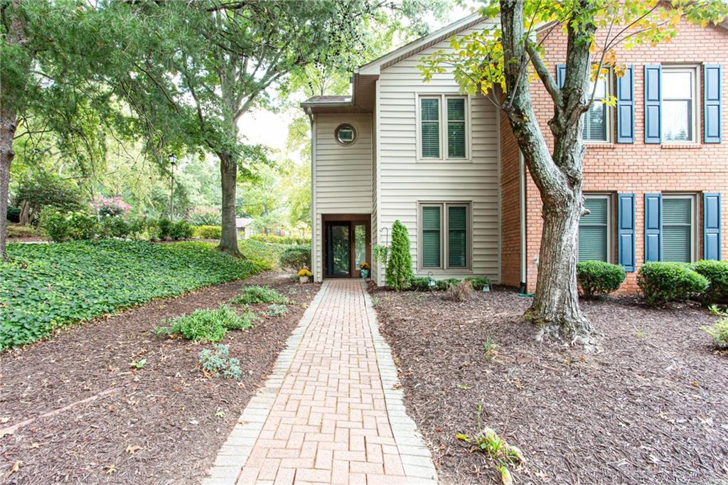 Adorable, renovated condo with a fantastic location to everything. This hidden gem is the perfect one level living around. Fully renovated kitchen features quartz countertops, sleek, new modern cabinets, updated flooring, tile backsplash, and SS appliances. Spacious family room with fireplace and open concept dining room. Oversized primary bedroom with large walk-in closet. Primary bathroom has updated double vanities with granite. Rare, covered patio out back with storage closet...very private. Courtyard is fenced and has mature landscaping. Quiet community with great amenities including a clubhouse, lake, pool and tennis. Minutes from I-285, GA 400, and top shopping/dining destinations.
