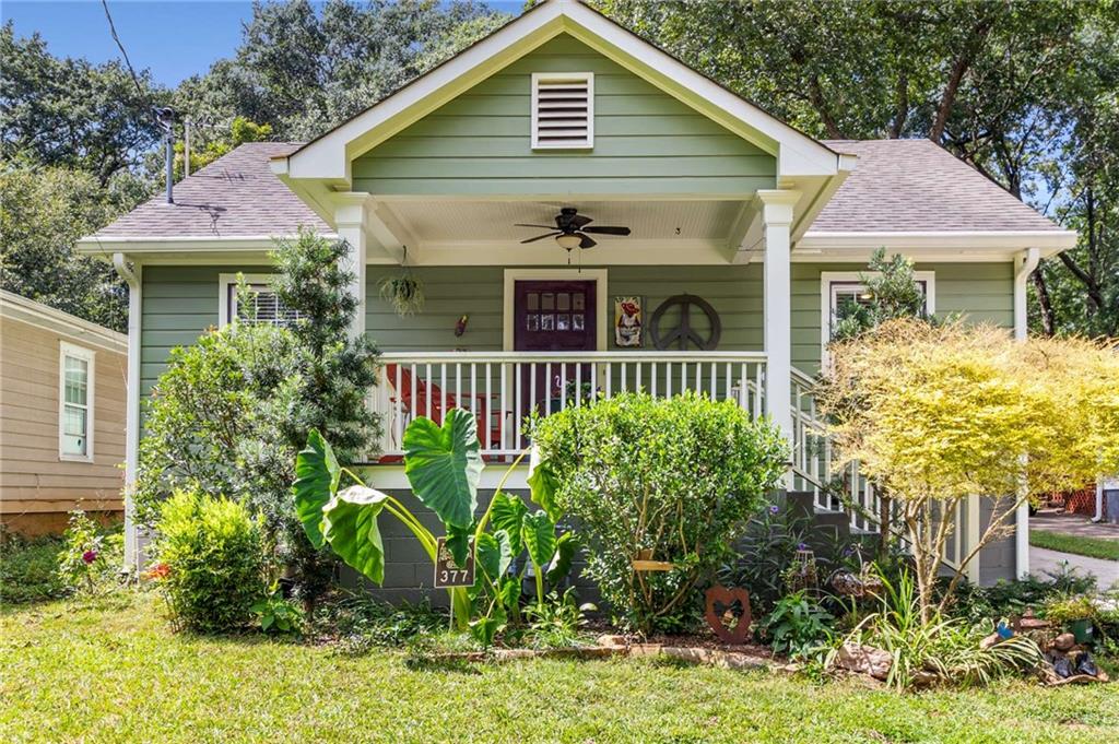 This classic East Atlanta bungalow blends historic character with modern updates, offering 3 bedrooms, 2 full baths, and hardwood floors throughout. The inviting front porch sets the tone—perfect for relaxing and connecting with neighbors. Inside, the living room flows seamlessly into the dining area, while the kitchen opens to a comfortable family room, creating an ideal layout for both entertaining and everyday living. The kitchen showcases natural wood shaker-style cabinetry, granite countertops, a peninsula with counter seating, stainless steel appliances, a gas range, and a pantry for extra storage. The spacious primary suite includes a walk-in closet and a beautifully updated bath featuring a double vanity and a large walk-in shower with a semi-frameless glass enclosure. Step outside to enjoy a deck overlooking the walk-out, flat backyard—an ideal setting for gatherings. The fenced yard offers a charming storage shed (or potential studio), a majestic Japanese maple, and a cozy fire pit. Located just a short walk from East Atlanta Village’s popular restaurants, bars, and nightlife, as well as Brownwood Park with tennis and basketball courts, this home offers the perfect mix of charm, convenience, and community.