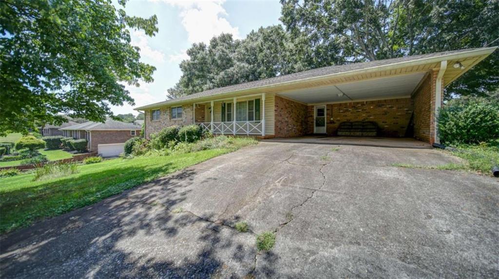 Quality-built ranch home located in the highly desirable Forsyth County school district. Offering 3 bedrooms, 1.5 bathrooms and unfinished basement, comfortable single-level living, this property provides both privacy and space to enjoy. Solid and a well-maintained structure give this home exceptional potential for customization - bring your vision and create the perfect space to fit your lifestyle. Inside, the home features a traditional ranch layout, ideal for easy living and accessibility. The large backyard offers a quiet retreat, perfect for morning coffee, afternoon barbecues, or gardening. Mature trees and established landscaping provide natural beauty and shade, while the generous yard offers opportunities for outdoor entertaining. Location is unbeatable - you'll enjoy the peace of a private setting while being just minutes from award-winning schools, shopping, dining, and quick access to GA 400 for an easy commute. Whether you are a first-time buyer seeking a great location, a downsizer looking for single-level convenience, or an investor searching for a property with strong potential, a little cosmetic updates make this one work!