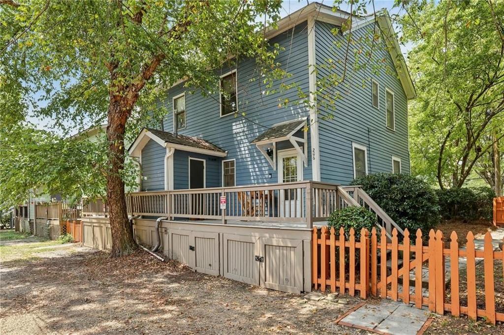 Rare two story historic duplex Cabbagetown with off-street parking right in the heart of the neighborhood! This fee simple duplex has two 2 bedrooms/1 bathroo townhouses that have solid rent history and a desirable location for short or long-term tenants. There are no rent restrictions and no HOA and each side of the duplex sits on it's own lot with it's own yard and parking area. Set on a quiet street, each unit blends original early 19th century character with thoughtful updates throughout. The main level features an open kitchen that flows easily into the dining and living areas. Hardwood floors and tall ceilings make the space feel bright and welcoming. Double porches at the front bring in natural light, while a spacious shady back deck creates the perfect spot for relaxing or entertaining. Inside each unit, you’ll find generous storage throughout, a renovated bathroom, and two sunny bedrooms upstairs - including one with its own walk-out balcony with city views. A side yard on both sides adds even more possibilities for gardening or pets. Amazing price for this location where you’re an easy stroll to shops and restaurants on Carroll Street, the Beltline, Grant Park, and Krog Street Market. Perfect for an owner occupant or, for someone looking to invest, short term rentals consistently bring in $3,000-$4,000 per month per unit. Home can be sold furnished.