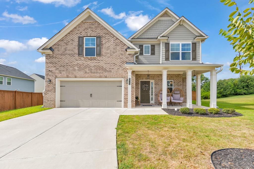 Welcome home to this beautiful 4 bedroom, 2.5 bathroom residence in the desirable Old Lost Mountain Estates community in Powder Springs! A charming covered front porch invites you in, where the foyer opens to a separate dining room, perfect for entertaining. The fireside family room flows seamlessly into a modern kitchen featuring white cabinetry, granite countertops, stainless steel appliances, a center island with seating, and a spacious pantry. A convenient half bath rounds out the main level. Upstairs, the oversized primary suite boasts tray ceilings, a luxurious ensuite bathroom with double vanities, a soaking tub, a separate shower, and a walk-in closet with built-ins. Three generously sized secondary bedrooms share a well-appointed full bathroom. Enjoy the outdoors from the rear patio overlooking the large, fenced-in backyard—ideal for relaxing or play. Additional features include an attached 2-car garage and a prime location in the McEachern High School district, with easy access to major highways, Marietta Square, and an abundance of shopping and dining nearby. Don't miss the opportunity to call this one yours!