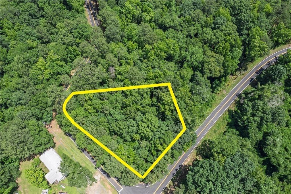 View of property location featuring a forest and property parcel outlined