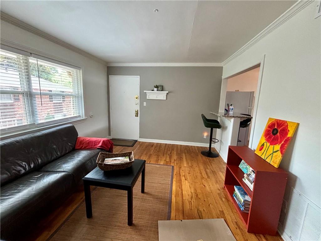 Located in Atlanta’s midtown Garden District, this 2nd story solidly built all brick condo is a Top Floor Unit. It has a spacious 2020 renovated kitchen with sparkling granite countertops, washer-dryer combo unit, gas stove, and abundant cabinet storage space. A built-in breakfast counter serves as both dining and workspace connecting to the living room. The low maintenance bathroom was renovated in 2024; it features a new deep soaking tub, sink, toilet, tile surround, tile floor, and a cavernous storage closet - in addition to under sink storage space. Both bedrooms are generously sized and have large walk-in closets with deep storage shelves. The warm looking vintage oak hardwood floors are everywhere except for in the master-craftsman tiled bathroom. Windows are double paned, open and shut easily, and have newly installed cordless blinds. HVAC was replaced in 2020 and has a programmable Nest thermostat. All the windows in unit have been replaced. The Palisades condominiums are tucked into a neighborhood filled with people who walk and bike to nearby stores, parks, restaurants, the Beltline, MARTA, museums, and downtown events. You’ll have a prime location assigned parking spot with this home. Finally, the modest HOA fee covers water, exterior maintenance, pest control, landscape services, and occasional community gatherings