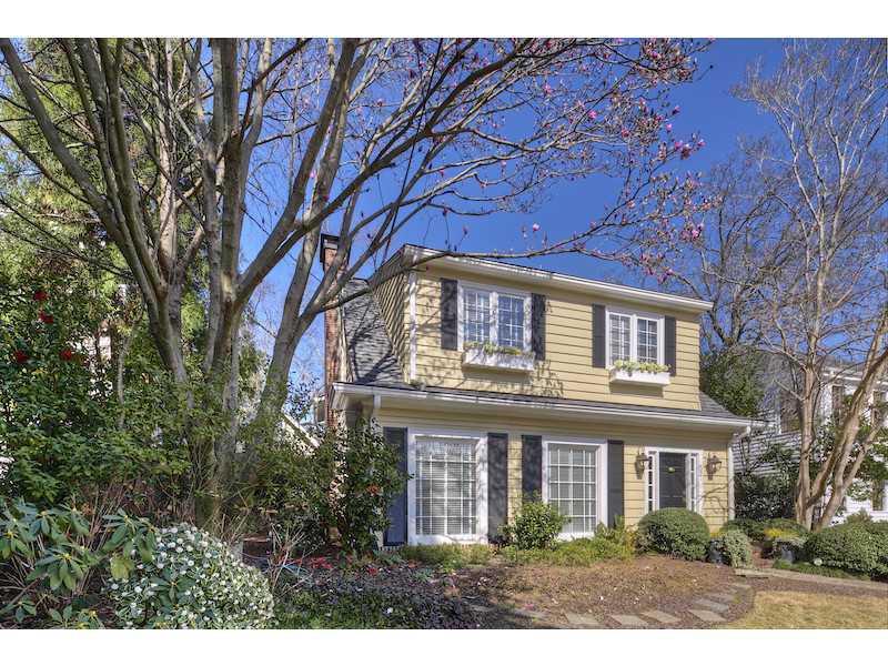 Ansley Park charmer! Updated w/vintage touches. Bonus family room in front w/built-ins. Flooded w/natural light thru-out. Spacious formal living room w/exposed brick fireplace. Tranquil, well landscaped backyard & separate garden w/koi pond. Hardwoods. New kitchen open to family room - granite countertops, abundant cabinetry, & wine cooler.  Built-in China cabinet. Large laundry room on main. Master suite w/separate sitting area, luxurious bath & gigantic closet space. Spacious secondary bedrooms. Attic access. Adorable carriage house w/bed & bath.