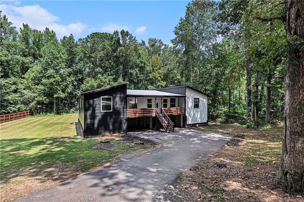 Investor Special! Home being sold As-Is! Welcome to this unique one-of-a-kind 4-bedroom, 4.5 bathroom home, with an attached in-law suite perfect for both relaxation and recreation. The expansive yard offers endless possibilities, whether you love to entertain or pursue outdoor hobbies. Inside, the open-layout kitchen is a showstopper with its modern design, brass accents, and a large island, ideal for both cooking and gathering. All bedrooms are conveniently located on the main level, with the primary ensuite featuring a luxurious soaking tub and sleek glassed shower. Enjoy outdoor living year-round on the screened-in back porch. There is a bonus room on the lower level that provides additional space, ready for you to customize into your dream area. Discounted rate options and no lender fee future refinancing may be available for qualified buyers of this home.