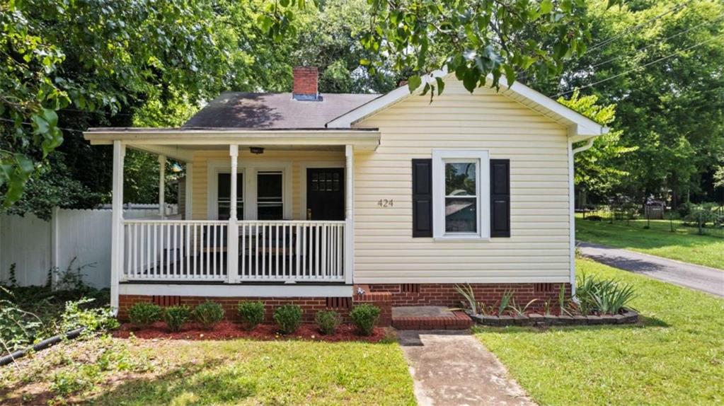 Step into timeless charm with this delightful three-bedroom, one bath cottage-style home. A welcoming covered front porch opens into a private, fenced outdoor sanctuary complete with a cozy fire pit- perfect for relaxing evenings or entertaining guests. Inside, the stylish kitchen shines with stainless steel appliances, combining modern conveniences with classic appeal. an outbuilding offers additional storage, rounding out the practical touches of this inviting property. Call for your private viewing today!