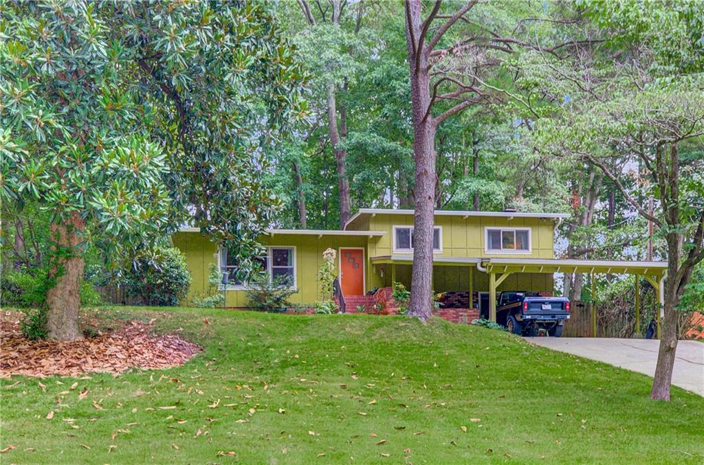 A midcentury modern masterpiece in Decatur that will simply stun you! From stained timbered ceilings to its time-capsule-esque midcentury vibe in every single room to a brick fireplace in the lower den level . .. this home frankly has everything you are looking for. The expansive living area on the main floor features a light filled living room with vaulted ceilings and original hardwood floors that naturally flow into the vibey kitchen and dining room. Continue to invite nature in with a screened porch and a fenced private backyard off the dining area. Entertainers will find this home dreamy, as a few steps downstairs will lead you to another den with built in wood shelving, a massive brick wall fireplace, a full bathroom, and a multifunctional laundry/utility room. A few steps upstairs in this split level floor plan offers three bedrooms, all with vaulted timbered ceilings throughout and hardwood floors, a full bathroom in the hall, and an ensuite half bathroom in one of the bedrooms. Enjoy all of the MCM aesthetic without all of the worry, as the owner occupant has completed almost every renovation you can think of including double paned windows, a roof, kitchen and bathroom renovations/updates, and more. Don't let this midcentury stunner pass you by, especially in a Decatur neighborhood with voluntary membership to the community pool.