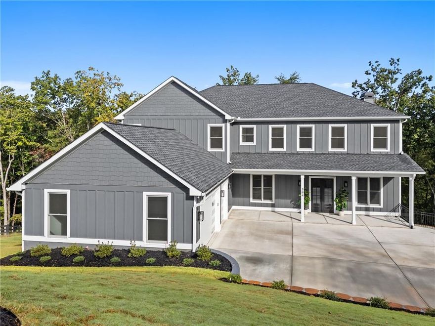 Tucked at the end of a quiet cul-de-sac in a private gated community, this exceptional new construction Ball Ground residence sits on a beautiful two acre lot offering both comfort and a sense of space. A brand new driveway leads to a three car garage with an electric vehicle charger. Inside, 10 foot ceilings and bright open spaces create an inviting spacious atmosphere throughout the home. The chef’s kitchen showcases a 48-inch gas range, pot filler, wine cooler and all new Thor stainless appliances. Custom under-cabinet illumination pairs beautifully with interior-lit glass display cabinetry, adding both function and a refined designer touch to the kitchen’s sophisticated aesthetic. The primary suite on the main level boasts a walk-in closet so large it could easily be called a walk-around! The main level laundry room includes a convenient dog bath for furry family members. Upstairs features five spacious bedrooms including two connected by a Jack-and-Jill bath and additional bedrooms each offering their own private ensuite. The spacious living room connects directly to a covered rear deck with a stone fireplace perfect for year round entertaining with seasonal mountain views. The terrace level basement spans 16 feet and is ready to accommodate an elite gym, home theater, game room & more. All of this is set within minutes of downtown Ball Ground and Jasper, where small-town charm meets modern convenience. Enjoy a vibrant local scene filled with boutique shops, cozy coffeehouses, breweries, and award winning restaurants such as Barrel House Coffee Co., Les Bon Temps, and The Old Mulehouse. Nearby parks, festivals, and community events provide year round activities, while easy access to Highway 575 connects you effortlessly to Canton, Woodstock, and beyond. Combining luxury, flexibility, and a desirable North Georgia lifestyle, 394 Settlers Ridge offers a rare opportunity to experience refined living surrounded by nature, convenience, and charm.