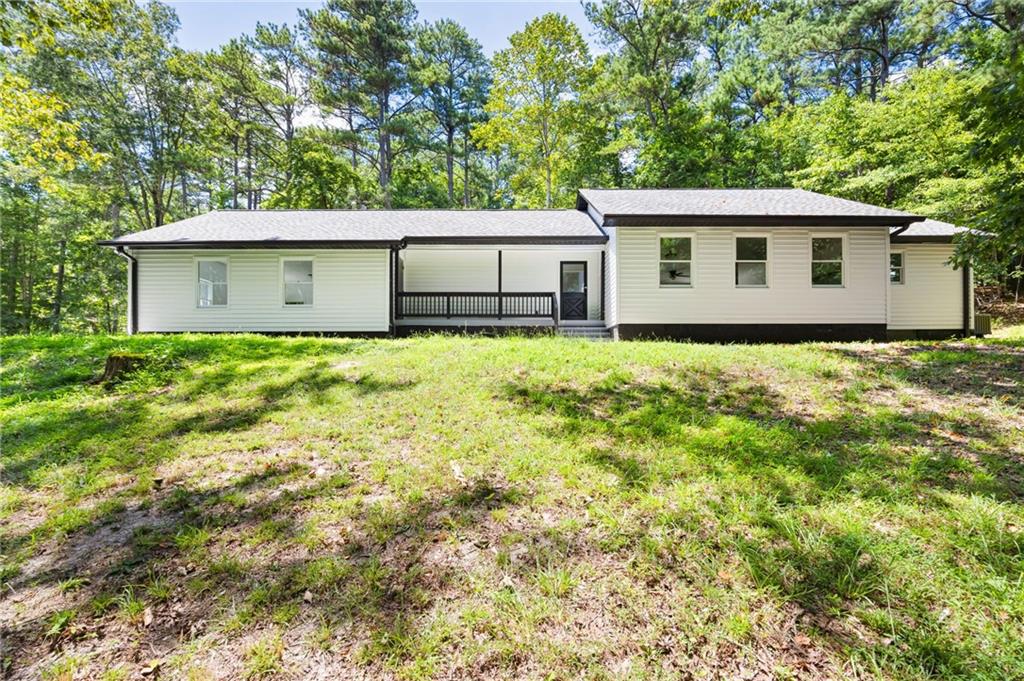 Huge shop, Renovated and over 5 acres! Welcome to your own slice of privacy in Paulding County. This beautifully renovated ranch-style home sits tucked off the road on a wooded lot with a winding gravel drive, a peaceful creek, and just the right mix of cleared space-perfect for a garden, chickens, or outdoor entertaining. Heavy lifting of new roof, floors, painting, repairs, added square feet-all done for you, move right in! Step inside to discover modern updates paired with classic comfort. The home now features a flexible third room-ideal for a home office, studio, teen lounge, or guest room-making this a smart and adaptable layout for all stages of life. The 40x60 metal shop offers serious space for a small business, hobbyist, or anyone in need of a garage, man cave, or workspace. With power, office space, and loads of storage, it's the kind of setup you just don't find every day. All this and just a short distance to Dallas, Villa Rica, and the Interstate.