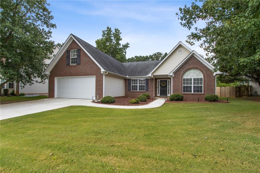 This beautifully updated ranch-style home is located in a desirable swim/tennis community within the highly sought-after North Gwinnett school district. The open split-bedroom floorplan includes a bonus room over the garage, perfect for a home office, guest space, or playroom. The vaulted great room features a cozy fireplace and opens to formal living and dining rooms, both with soaring ceilings that enhance the home's spacious feel. The fully renovated eat-in kitchen is a chef’s dream, boasting quartz countertops and backsplash, tile flooring, a stainless steel 6-burner gas range, pot filler, vented hood, and plenty of cabinet space. Throughout the home, luxury vinyl plank flooring offers both durability and style. The spacious primary suite on the main level features a tray ceiling and a completely renovated en-suite bathroom with quartz countertops, a jacuzzi garden tub, separate tiled shower, and a large walk-in closet. A bright and airy sunroom overlooks the fenced backyard, providing the perfect space for relaxing or entertaining. Conveniently located just minutes from I-85, top-rated schools, shopping, dining, and parks, this home blends comfort, style, and location in one exceptional package.