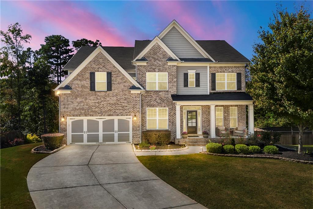EXTRAORDINARY TRIPLE-LEVEL BRICK PALACE… Boasting nearly $250,000 in custom upgrades, this stunning pet-free immaculate luxury home is in one of the highest-rated school districts of renown Gwinnett County. Minutes to the Mall of GA, this like-new home is nestled in heart of very quite cul-de-sac. Level driveway leads to large, front covered porch… Enter home with formal office, formal dining room, and extra-large Grand room with “bowed” palladium windows- allowing a bright interior home. This entertaining open concept floor plan has a unique “Keeping Room” off the kitchen, providing a secondary entertainment area- can also be a sun room- yes, this home features a one-of-a-kind custom floorpan that sets it apart from the others! Full guest suite on main. Heavy trim package… Gourmet chef’s kitchen with every luxury! Upper level features 4BRs/ 3 full BAs/ and an awesome 5th “step up” media room or 2nd office! Unique laundry room has private “pass thru” to elegant owner’s bedroom suite. Almost no carpet- first & second floors hardwood, engineered wood- with basement level quality LVP. Terrace level is built out NICE!!! Features: Full guest suite with nicely appointed bath; game room or billiard room; bar or 2nd kitchen; theatre/ media room; and double-sized storage centers. Exit basement to super-sized screened in patio- overlooking BIG BIG sodded soccer-sized and level fenced yard- perfect for pool or play or gardening- and with amazing privacy… Some add’l notable features: (2) hot water heaters of 100 gal total; basement refrigerator remains- as well as the theatre seating. Being custom built in 2017 this home is only 9 yrs young and meticulously cared. Even comes EV-prewired at the garage! Community is very new, built out- and also has a wonderful family sports center. This gem has the WHOLE PKG folks… A sure-to-please winner on your list!