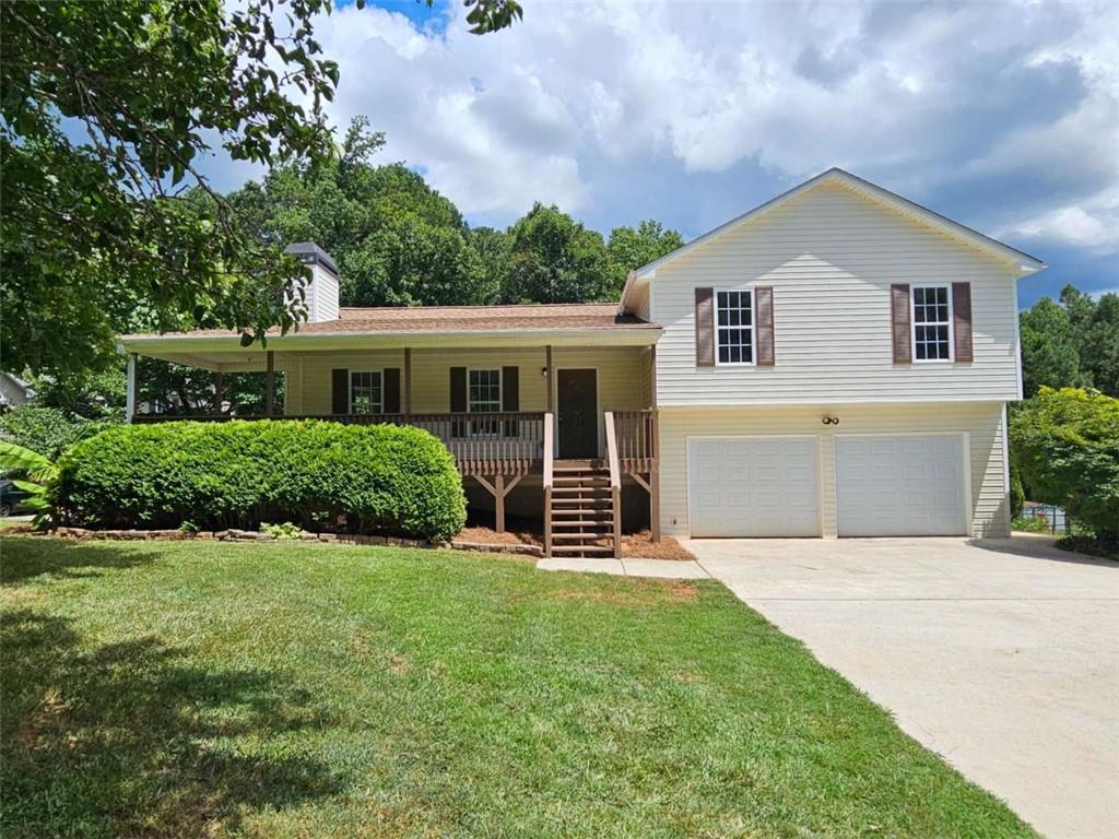 This beautifully renovated split-level home is located in a 100% USDA financing area with NO HOA-perfect for those seeking space, privacy, and convenience. Enjoy Southern charm from the expansive covered wrap-around front porch, leading into the main level featuring beautiful LVP flooring and a vaulted family room with a cozy fireplace. The fully renovated kitchen boasts new cabinets, granite countertops, stainless steel appliances, and a bright dining area with a bay window. Upstairs offers 3 bedrooms and 2 full baths, including a primary suite with a trey ceiling, walk-in closet, and updated en-suite with dual sinks with granite top, a soaking tub, and separate shower. Just a few steps below the garage level with door openers, you'll find a huge bonus room-ideal as a 4th bedroom, media room, or home office. Outside features a fenced backyard, great back deck, and easy access to the covered front porch. New updates include flooring, fixtures, appliances, HVAC, water heater, interior/exterior paint, and more. Conveniently located near Villa Rica, Temple, and Dallas! FHA Eligible: 8/28/25