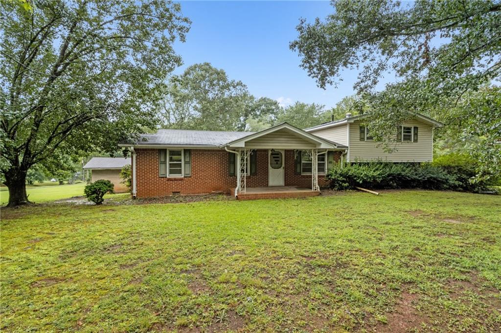 Charming Fixer-Upper on 1.04 Acres – No HOA! This spacious home is full of character and potential, perfectly situated on approximately 1.04 acres with NO HOA restrictions. Featuring original hardwood floors beneath most of the existing flooring, this home is ready for your personal touch and updates. Enjoy a large, open kitchen ideal for cooking and entertaining, and a generously sized great room complete with a masonry fireplace—perfect for cozy evenings. The primary suite offers two walk-in closets and a spacious bathroom with a double vanity, tiled flooring, and a walk-in shower. Conveniently located just minutes from Georgia Gwinnett College, the Mall of Georgia, the Gwinnett Stripers Triple-A baseball stadium, and a wide variety of shopping, dining, and entertainment options. Don’t miss this opportunity to own a home with great bones and room to make it your own! Two Adjacent homes at 83 & 95 Russell Rd. FOR SALE as well for a total of 6.64 acres & 3 homes. Create a nice family compound!